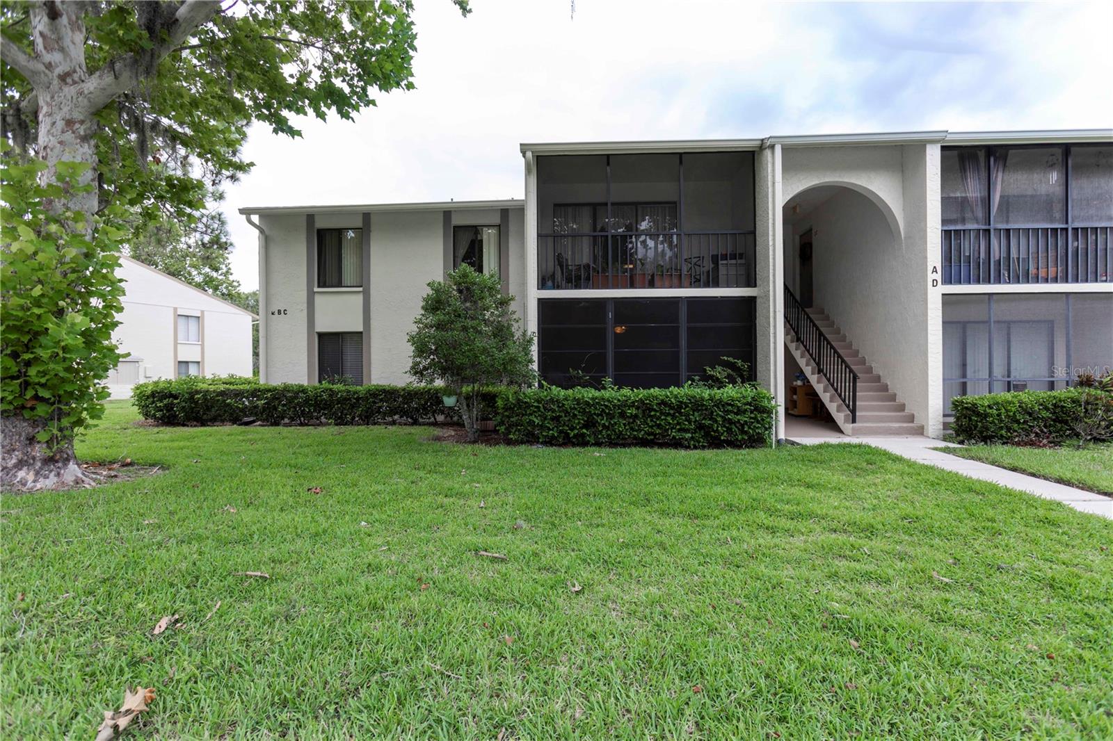 Absolutely one of the most desirable condos in the entire community—this stunning 2-bedroom, 2-bath corner unit is located on the first floor with only one shared wall for added privacy and comfort. Step inside to find gorgeous luxury vinyl flooring and ceramic tile throughout, offering both style and easy maintenance. The remodeled kitchen features beautifully updated cabinetry, an abundance of storage, and expansive counter space that flows seamlessly into the open living area—perfect for entertaining. Both bathrooms have been refreshed with new vanities and granite countertops, elevating the space with a modern touch. The spacious master suite boasts two windows that fill the room with natural light, a generous walk-in closet, and a private en suite bath with a walk-in shower. You’ll also enjoy the convenience of a private laundry room with extra storage space. This unit comes with a designated parking spot right in front, and it’s located steps from the clubhouse, resort-style pool, spa, tennis courts, and a playground just outside your door. Take in serene views and peaceful walks along the lakefront walking trail. The community is known for its friendly, neighborly atmosphere—where people genuinely look out for one another. With a low HOA and unmatched amenities, this condo is a rare find and won’t last long. Schedule your showing today before it's gone!