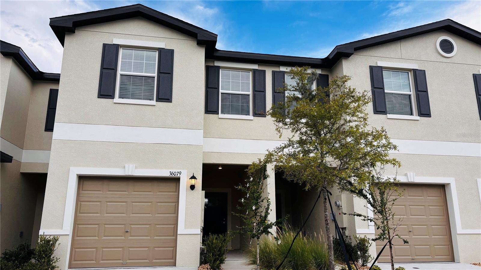 Move right into this stunning BRAND NEW 3-bedroom, 2.5-bath townhome with loft and 1-car garage. Bright & spacious with open floor plan, tile downstairs, carpet upstairs. Modern kitchen with stone counters, shaker cabinets, pantry & all appliances included. Upstairs, you’ll find all bedrooms plus a convenient laundry room with washer & dryer. The primary suite offers a walk-in closet and ensuite bath with dual sinks and a walk-in shower. The loft space is perfect for an office, playroom, or reading nook. Relax outdoors on the screened lanai overlooking a peaceful pond view. Small pets welcome! The Townes at Windsong community is ideally located near Wiregrass Mall, Tampa Premium Outlets, The Grove, medical centers, restaurants, and easy interstate access.