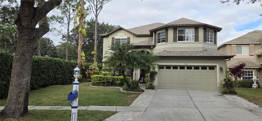 PROFESSIONAL PHOTOS COMING! Welcome to your dream home in the highly sought-after Heritage Harbor community! This impressive 6-bedroom, 3-bath saltwater pool home boasts a premium location on the first tee of the golf course, offering side water views, a spacious corner lot, and ultimate privacy with only one neighbor. Set on a cul-de-sac, this home provides the perfect blend of luxury, comfort, & convenience. Families will appreciate the home’s proximity to some of the best education in the area. All three US News Award-Winning schools—elementary, middle, and high—are located together on a picturesque campus less than two miles from your doorstep. As you approach, you're welcomed by a lovely landscaped front yard that sets the tone for the elegance found within. The expansive, private paver lanai features a beautiful saltwater pool with therapeutic jets & bench seating, a screen enclosure (2017), & panoramic views of both the tranquil pond and the vibrant golf course. Elegant Interior features soaring ceilings & luxury flooring.  Step inside to find high beautiful marble flooring, creating a bright and airy ambiance throughout the main living areas. The dining room, adjacent to the front living room, is graced with expansive windows, offering an abundance of natural light. The gourmet eat-in kitchen features granite counters, an island, breakfast bar, stainless-steel appliances, closet pantry, & ample cabinetry—this kitchen opens to a spacious family room with hardwood floors & a cozy wood-burning fireplace. The main floor guest suite offers a generous bedroom that is perfect for guests, complemented by an updated bathroom featuring a contemporary vanity and tile backsplash. Ascend the staircase adorned with newer carpeting to reach the expansive upper level, where the master suite & four inviting guest bedrooms await. The master suite impresses with its generous proportions, highlighted by laminate flooring and a recently installed fan. Step into the luxurious master bath, to include dual vanities for ample space, a garden tub for soaking, a separate tiled shower, and a spacious walk-in closet. This home features four generously sized guest bedrooms. Among these, one standout bedroom boasts an elegant double-door entry. The third bathroom has been tastefully updated. All the additional bedrooms also benefit from newly installed carpeting. Step out back to your private, expansive lanai to cool off in the saltwater pool or simply unwind while enjoying the peaceful pond views and the excitement of golfers teeing off nearby. Other amazing features include… Roof 2020, both A/C’s replaced in 2018 & 2019, front door 2016, updated water heater, remote control fans, newer oven & microwave, water softener, newer exterior paint, newer carpet in most bedrooms, & a Tesla charging station in the garage. This home is close walking distance to the pool & all Heritage Harbor amenities. Heritage Harbor offers residents can enjoy the 11,000 square-foot Clubhouse featuring a fully equipped fitness center, a dedicated after-school/summer camp program, a library, and activity center for all ages. Pre-school programs are nearby. Equipped with a playground, a quarter-acre swimming pool with a 50-foot, three-story water slide, 4 tennis courts, a sand volleyball court, basketball hoops, an outdoor rollerblading rink & golfers will delight in the Heritage Harbor Golf Course, a par-72, 6,900-yard course. Prime location, just minutes to the Suncoast Parkway.