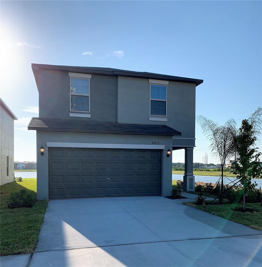 Welcome to the Touchstone Community! This 4-bedroom, 2.5-bathroom home with a two-car garage sits on a peaceful lakefront lot, offering comfortable living with beautiful water views. The home features ceramic tile flooring throughout the main living areas and carpet in the bedrooms for added comfort. Large windows allow for plenty of natural light, creating a bright and open feel throughout the home. The kitchen is designed with both functionality and entertaining in mind, offering ample counter space, a center island, a large pantry, and a breakfast bar that overlooks the main living and dining areas. Sliding glass doors lead to a covered lanai, providing a great spot to relax and enjoy the lake views. The primary suite offers a spacious retreat with a walk-in closet, dual vanities, a garden tub, and a separate glass-enclosed shower. Upstairs, a versatile loft area provides additional living space that can be used as a home office, media room, or play area. Three additional bedrooms offer comfortable space for family members or guests. Residents of Touchstone Community enjoy access to community amenities including a resort-style pool, clubhouse, fitness center, and park areas. The location also provides convenient access to the Lee Roy Selmon Expressway, making it easy to commute to downtown Tampa, Tampa International Airport, and MacDill Air Force Base. Shopping, dining, and everyday conveniences including Publix are also located just a short drive from the community. In addition to the advertised base rent, all residents are enrolled in the Resident Benefits Package (RBP) for $50.00/month which includes HVAC air filter delivery, credit building to help boost your credit score with timely rent payments, utility concierge service making utility connection a breeze during your move-in, and much more! More details upon application. Pets are welcome, no aggressive breeds. Washer and dryer are included. Vacant and Available now!