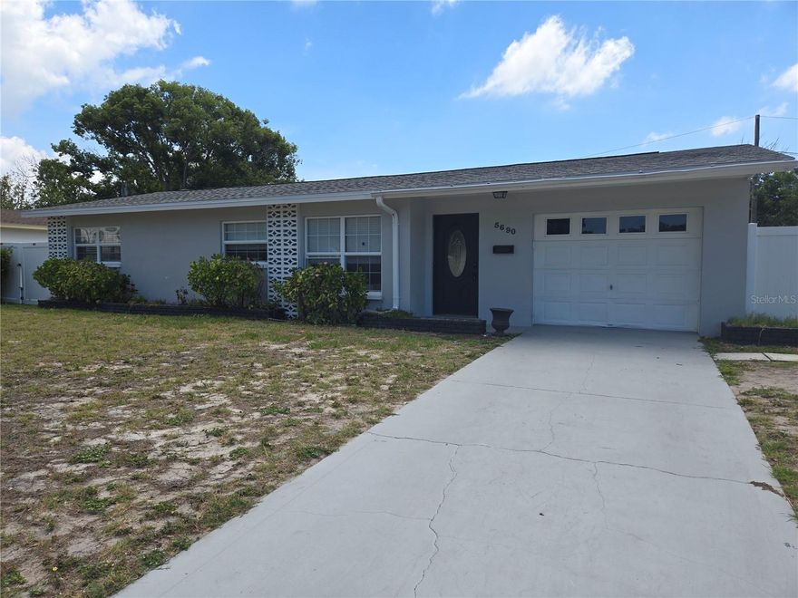 Discover the perfect blend of style, comfort, and modern updates in this 3-bedroom, 2-bath block home offering 1,324 square feet of thoughtfully designed living space. Completely renovated just three years ago, this move-in ready residence sits on a spacious 77x100 ft lot with a newer vinyl-fenced backyard, providing privacy and plenty of room to relax or entertain. The split floor plan features a private primary suite complete with an adjoining office space and a stunning ensuite bath showcasing a custom tiled shower. The heart of the home is the designer-inspired kitchen featuring quartz countertops, stainless steel appliances, and custom-style cabinetry that combines beauty with functionality. Easy-care luxury vinyl flooring flows throughout the home, adding warmth and durability. An attached garage provides convenient parking, additional storage, and a dedicated laundry area with included washer and dryer. Step outside to the covered rear patio, the perfect spot for entertaining guests, outdoor dining, or simply unwinding at the end of the day. Ideally located just 10 minutes from vibrant downtown St. Petersburg, 15 minutes from the beautiful shores of St. Pete Beach, and with easy access to I-275 for convenient commuting to Tampa or the Bradenton–Sarasota area, this exceptional home offers the perfect combination of location, lifestyle, and modern living.