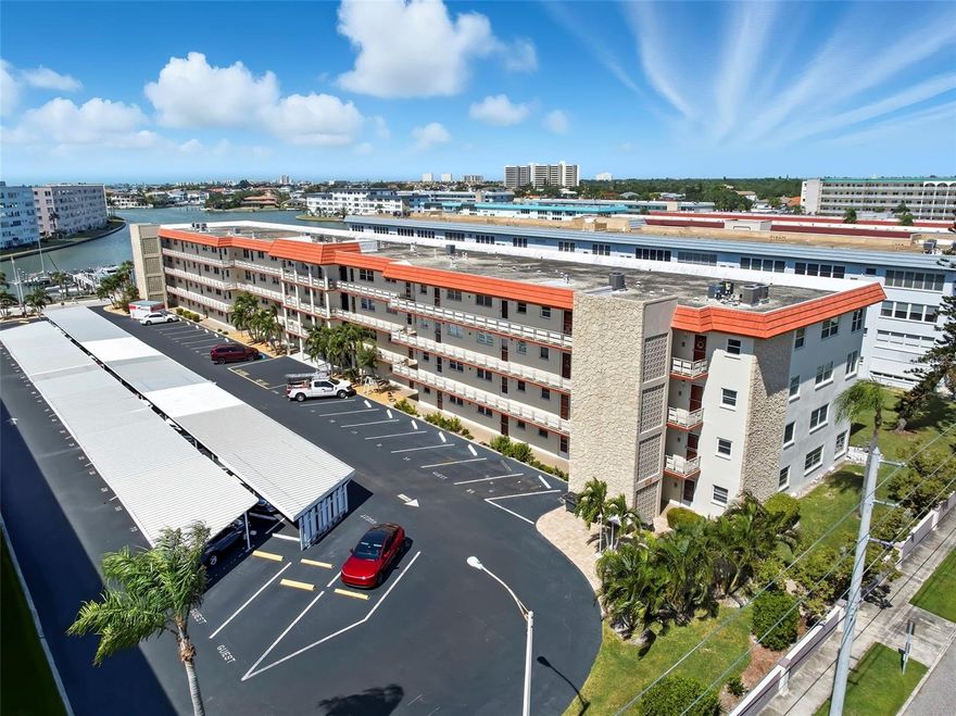 This move in ready deluxe floor plan features an open layout and a light and bright bonus room with wall to wall windows and additional storage.  The many recent updates include appliances, upgraded plumbing and electrical, updated bathrooms, luxury vinyl and tile flooring, and energy efficient impact rated windows.  Additional features of this home include an assigned parking space and laundry on the same floor.  Town Shores is an active 55+ community that sits on the waterfront about a mile from downtown Gulfport. Just a short drive away are popular downtown St. Petersburg and St. Pete Beach.  The community boasts 2 waterfront pools plus 2 additional pools, a fitness center, tennis court, shuffleboard courts, pickleball, bocce ball, a clubhouse with cards & billiards areas, dog park, BBQ & picnic areas, kayak storage, and a marina.  The Dover Building is pet friendly and located just steps from the marina docks.  Relax at one of the 4 pools, breathe in some salt air on the beach, hop on your boat for a sunset cruise, or enjoy the charming markets, art, music, food, and festivals that this area is known for.  Schedule your showing today and claim your slice of paradise!!