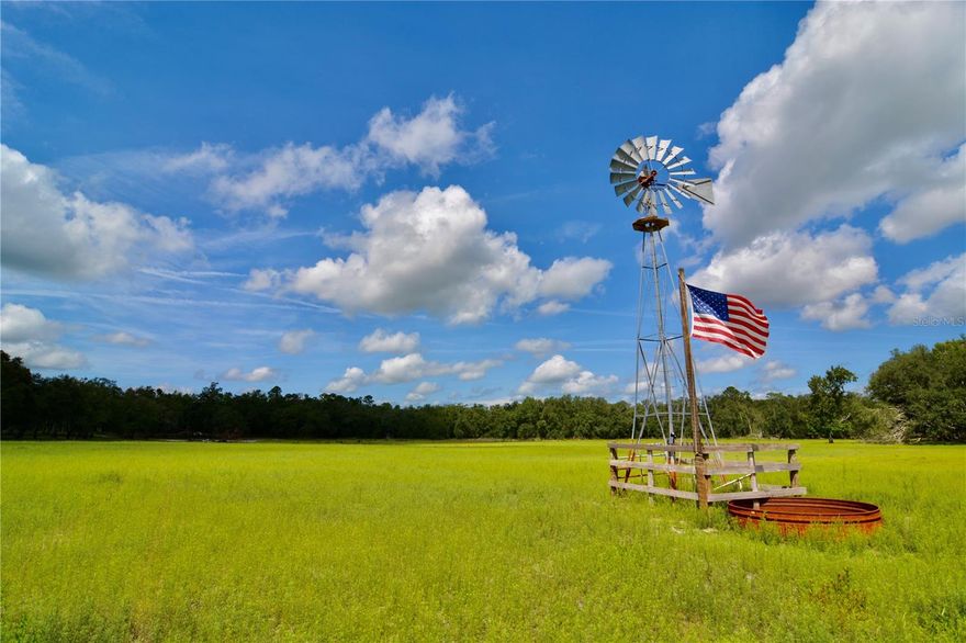 This turnkey North Florida property is a rare blend of working cattle farm, hunting land, and recreational retreat. Impeccably managed and fully cross-fenced, it features lush green pastures, mature live oak hammocks, and two ponds, creating both a productive and visually stunning landscape. An agricultural building with two large pull-through bays and on-site living quarters / apartment adds functionality and comfort. The land is well-equipped with power in three locations, three wells, and irrigation plumbed to multiple water troughs throughout the property. Abundant wildlife—including deer, wild turkey, and waterfowl thrive in its diverse habitat. On the southeast corner lies a 17-acre stand of mature planted slash pine, ready for harvest and offering immediate timber value. With four convenient access points and a thoughtful layout, this pristine and versatile tract stands out as a true gem in North Florida—perfect for farming, hunting, and long-term investment.