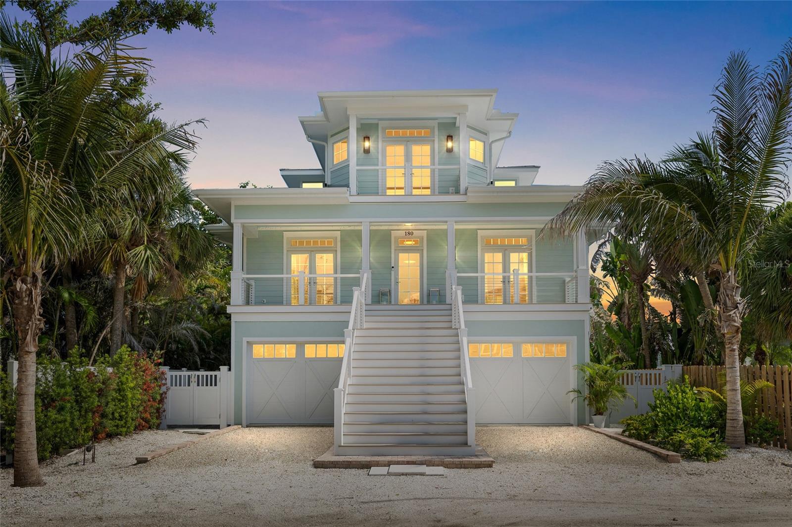 Coastal Luxury Meets Thoughtful Design – Completed in October 2024, this beautifully crafted 4-bedroom, 3.5-bath residence offers a perfect blend of coastal charm and modern luxury. Inside; engineered white oak hardwood & custom tile work throughout, accented with Serena & Lily wall coverings and Pottery Barn window treatments elevating the interiors. An elevator all three levels and two sets of washer/dryers on the two elevated living levels add comfort and convenience. The main living level features two en-suite bedrooms & bathrooms, tasteful dining area including bar cabinets for ease of service off the kitchen & bar dining features off the living room, also overlooking the waterfront! The Master level offers a spectacular en-suite with two large banks of built-in cabinetry with a spacious walk-in closet. Top level back bedroom/den/office/library smartly enhances the Master experience. Ground level 2 car plus golf cart+ garage offers lots of storage, even more air-conditioned storage & excellent bonus space. The bunk room showcases custom-built beds, creating a perfect retreat for the youngsters.
The exterior is built to the highest standards with Hardie board siding, spray foam insulation, hurricane-rated windows and doors, and rebar-reinforced walls—ensuring peace of mind with zero structural impact from recent Storms. Features include tile flooring and Azek batten board detailing, providing both durability and style. The roof system is engineered with high-quality trusses and finished with premium roofing materials for long-lasting protection. Stucco and siding are complemented by custom exterior accessories such as corbels, shutters, and awnings for a refined coastal look. Outdoor living is enhanced with expansive decking, handrails, aluminum screen systems. Additional highlights include a pool and spa with paver surrounds, professional landscaping, and a paved driveway and walkways that complete the enchanting curb appeal.
Outdoor living shines with four covered porches, a main level also screened porch features a full summer kitchen and grill overlooking the pool out to the dock! Master level French doors lead out to another spacious covered deck overlooking the also covered boathouse—with some Harbor view! A large outdoor shower off the sparkling pool by Tropical Pools, out to the private covered dock with two custom 20,000 lb lifts and room for an additional skiff. Multiple storage closets and lockouts provide excellent space for gear and organization.
This home is designed for effortless coastal living with every detail thoughtfully considered. A must-see for a New Construction aficionado!