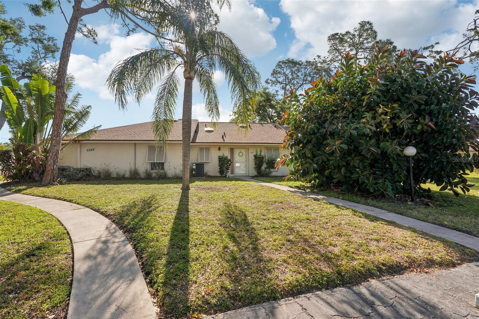 One or more photo(s) has been virtually staged. Beautifully updated, this two-bedroom, two-bathroom villa in Royal Palm Villas offers stylish comfort and thoughtful updates throughout. A brand-new roof (2025), fresh interior paint, updated light fixtures, switches, and outlets bring a bright, modern feel to the home. New light, neutral carpet adds a cozy touch to the bedrooms, while a new storm door with a retractable screen enhances both curb appeal and functionality. The updated kitchen features new countertops, sink, faucet, and stove, along with a convenient breakfast bar that opens seamlessly to the dining and living areas. Sliding glass doors lead to an enclosed lanai/Florida room—perfect for added living space or year-round relaxation. The smart split-bedroom layout provides privacy, with the guest bedroom and full hall bath located at the front of the home. The spacious primary suite is tucked away at the rear and offers private access to the lanai, along with an en-suite bathroom. Both bathrooms have been tastefully refreshed with new toilets, faucets, and light fixtures. Located in the heart of North Sarasota, Royal Palm Villas offers a peaceful community setting with easy access to shopping, dining, parks, top-rated schools, and the beautiful Gulf Coast beaches. Enjoy the convenience of low association fees that include cable TV, community pool, exterior and grounds maintenance, insurance, sewer, trash, and water. This villa blends modern updates with Florida charm—don’t miss the opportunity to make it yours!