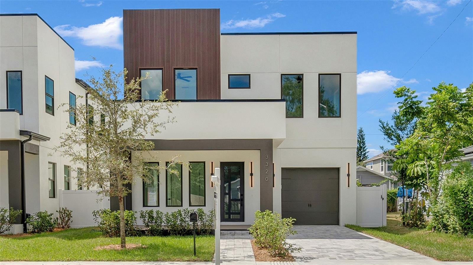 Experience contemporary LUXURY in this newly completed home designed with premium upgrades and peace of mind at every turn. From the moment you walk through the 8-ft impact entry door, soaring 10-ft ceilings, and high-polished tile floors create a dramatic and open feel. The chef’s kitchen is a true showpiece with waterfall quartz countertops, sleek high-gloss cabinetry, built-in microwave, and striking gold finishes that elevate every detail. A formal dining room, spacious family room, and stylish guest bath complete the first floor, while the epoxy-coated garage with an impact door provides both durability and function.
Upstairs, wide-plank luxury vinyl flooring flows into each bright and spacious bedroom. The primary suite is a true retreat with an oversized walk-in closet, spa-inspired bath featuring a freestanding tub, floor-to-ceiling tiled shower, quartz dual vanities, LED mirrors, and matte blackfinishes. Two additional bedrooms boast large picture windows and walk-in closets, while the upstairs laundry offers tall high-gloss cabinets for added storage and convenience.
Every detail of this home is thoughtfully crafted for modern living, style, and comfort. Best of all, it’s located in an X NON Flood Zone, less than 9 minutes from vibrant Downtown St. Petersburg and just 19 minutes from Tampa International Airport delivering luxury living in a prime, convenient location.