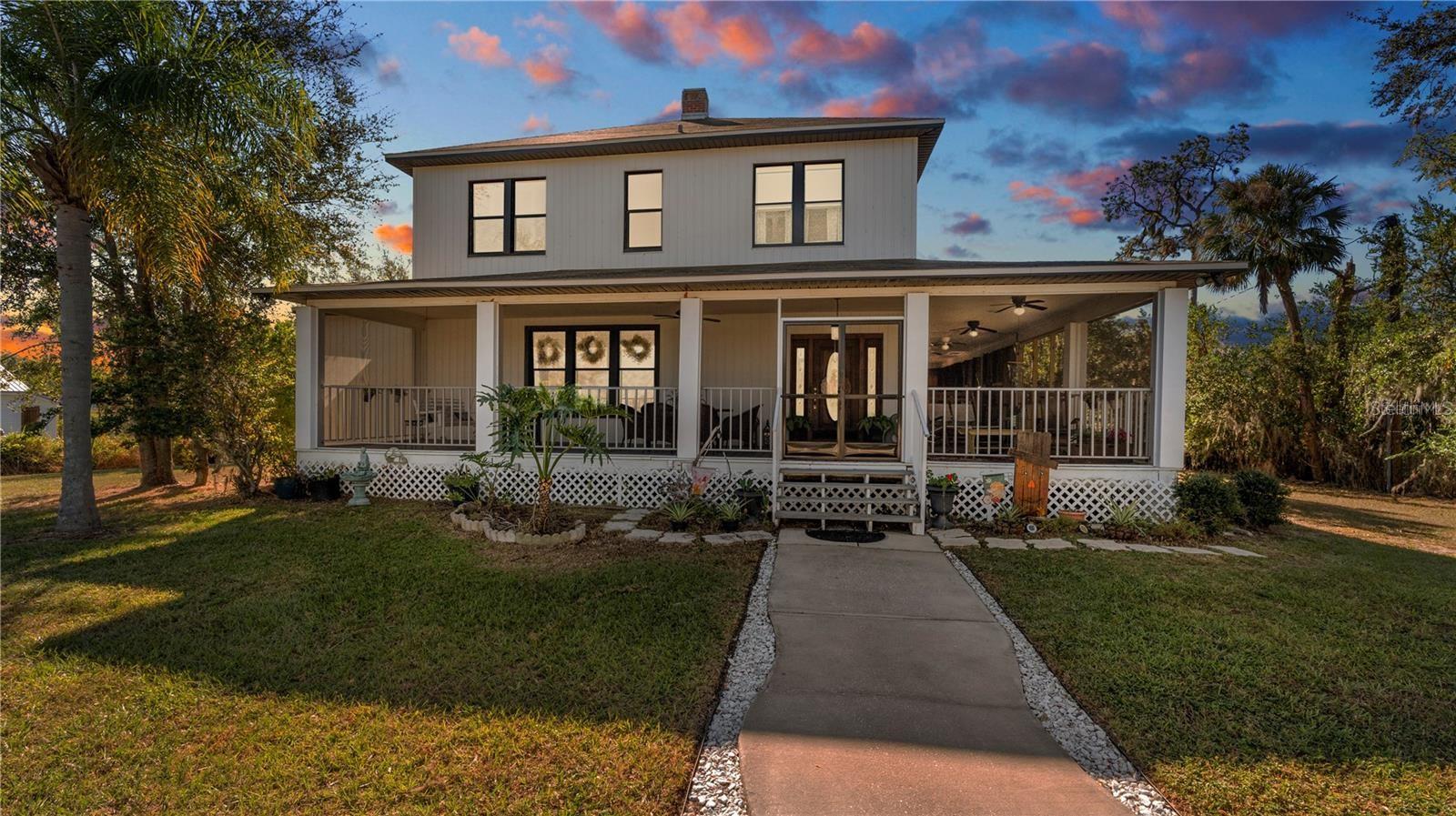 Step back in time with timeless charm and modern comfort! Built in 1923, this beautifully preserved home blends historic character with thoughtful updates. Nestled on a spacious lot, it boasts a stunning wrap-around porch perfect for relaxing, entertaining, or simply taking in the serene lake views at sunset. Inside, you’ll find original details like high ceilings, wood accents, and a warm, welcoming layout. The living spaces are generously sized, with natural light pouring in through large windows. Whether you're sipping morning coffee on the porch or unwinding in the evening as the sun sets over the water, this home offers peaceful living at its best. Offering 4-bedroom, 3.5-bathroom with a loft/office home located in the heart of Mulberry, Florida. The kitchen boasts cabinetry, ample counter space, and plenty of room for meal prep, making it a great spot for home-cooked meals. Since 2023 this home offers new interior and exterior paint, one of the two AC units has been replaced, new detached garage, RV carport with connection, all new siding and so much more. Situated just minutes from local schools, shopping, and dining, this home offers easy access to major highways for commuting to surrounding areas. Don’t miss out on the chance to own this charming property!