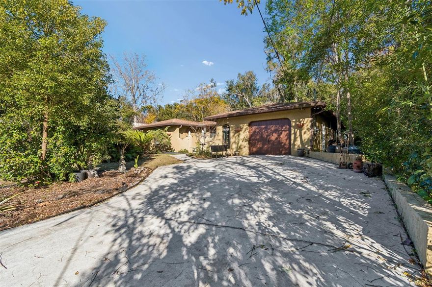 This charming 2-bedroom, 2-bath home with a one-car garage is ideally located in the heart of Dade City. Upon entering the foyer, you'll find a sunken formal living and dining room that creates a welcoming and spacious atmosphere. The kitchen features a large wraparound bar that accommodates the whole family and a cozy dinette, while also overlooking the living area—making it perfect for everyday living and entertaining. The generous primary bedroom includes an en-suite bath with dual sinks, a walk-in shower, and convenient dual-entry access. The second bedroom is filled with natural light. Additionally, sliding glass doors lead to a screened lanai that overlooks an expansive, fully fenced backyard—ideal for relaxation, pets, or outdoor gatherings. The roof, A/C, and Hot water heater have all been replaced with-in the last 8 years.