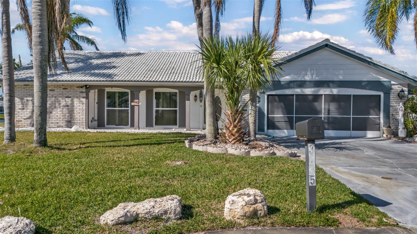 Experience amazing panoramic water views from this stunning 3/2 situated at the end of a quiet cul-de-sac! Upon entering this well-loved home, you’ll walk through the spacious L-shaped living and dining areas, which provide stunning views through the large screened-in, paved lanai overlooking the lake and your impressive 148 feet of water frontage, complete with a dock. Mature tropical landscaping along the sides of the house offers both privacy and serenity, making it a perfect spot to watch birds and wildlife while enjoying breathtaking sunsets from the incredible lanai.
The large kitchen has been thoughtfully updated to include wood cabinets, stunning granite countertops, and stainless steel appliances. Recently added French doors leading out to the lanai, enhancing those magnificent water views. Wake up to the serene water view from your generous-sized master bedroom, which includes an ensuite bathroom with a modern tiled shower stall and a walk-in closet. The AC was replaced 9 months ago.
This split floor plan offers privacy, with the second bedroom also enjoying incredible views through a floor-to-ceiling window, adjacent to a hall bathroom with a tub. The home includes a laundry room with a washer and dryer, as well as ample storage and pantry space. The large two-car garage features built-in storage cabinets and workspaces, making it convenient for various hobbies. All windows have been recently replaced for added efficiency.
Centrally located, this home is just a short distance from the Gulf waters, Key Vista Nature Parks, hiking trails, fishing spots, marinas, boat ramps, and beautiful beaches, along with a park situated at the mouth of the Anclote River. Nearby historical Tarpon Springs, with its charming restaurants and quaint shops, adds to the allure of this remarkable property!.This home also has proven VRBO income.
