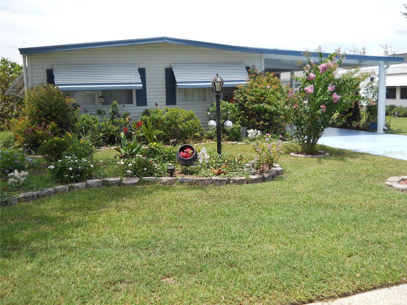 Beautiful Turnkey home located in Orange Blossom Gardens. Just bring your toothbrush. NO BOND. Recently renovated with 2 bedrooms and 2 new baths with top end fixtures. The hall bath has an impressive soaking tub, and the master bath has a new shower with multiple heads. The roof was installed in 2021, the hvac was replaced in 2021, the hot water tank and water softener were replaced in 2024. The kitchen was updated with granite tops, new backsplash and stainless-steel appliances in 2021. The home includes an enclosed front porch/ Florida room and a screened in lanai. The washer/ dryer is new in 2025. Please be sure to check out the new light fixtures/ fans and the new plumbing fixtures. The home also includes a spacious laundry room plus a storage room. The primary bedroom has 2 closets. This is a lot of value in a great location, only minutes by golf cart to the Orange Blossom recreation areas, pool, golf course or to Spanish Springs town square. Welcome to The Villages.