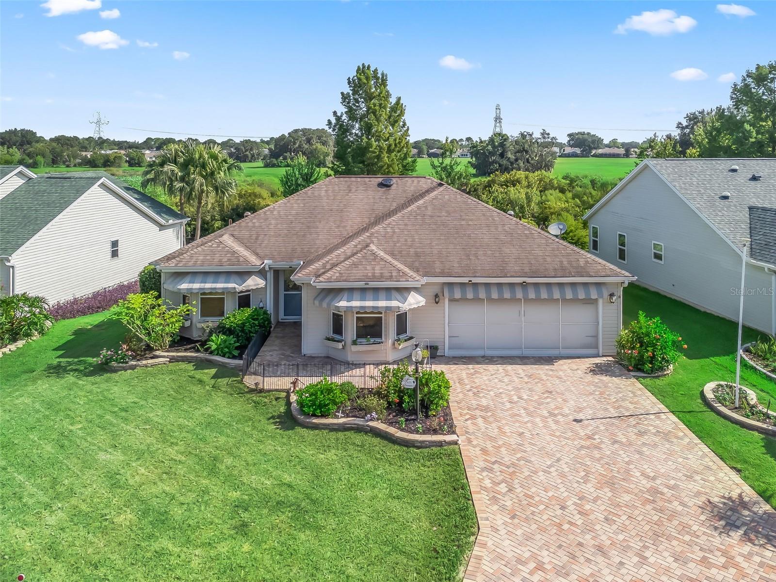 Your Private Paradise Awaits! Exceptional Custom POOL home situated on Grass Pond with a View of the Morse Wildlife Preserve! No Rear Neighbors! 3/2 Expanded Wisteria/Sedona III in the Village of De La Vista West! NO BOND! This highly sought after Village of De La Vista West is conveniently located between Lake Sumter Landing and Spanish Springs Town Square, where you can enjoy nightly Entertainment 365 days a year! This Expanded Wisteria/Sedona III model offers a 2 Car Garage with sliding Screen doors, Stunning Paver Driveway and Walkway, an Open Concept and Split Floor plan with Vaulted ceilings, Crown molding, 2 Skylights, No Carpet, and a Spacious Dining and Living area combination featuring sliding door access to the Covered Lanai, and POOL area with a Birdcage Enclosure, creating a Spectacular Space for Social Gatherings, and Relaxing with Family! The Large Eat in Kitchen showcases Corian countertops, Stainless appliances, Pantry Closet, Wood cabinets with Pullouts, Crown molding, Vaulted ceiling, a Butler's window to the Dining area, Beautiful Bay windows, and a Breakfast bar. The Split Floor plan provides Maximum Privacy for both the Owners and their Guest, with the Primary Suite commanding one side of the home, while the guest bedrooms and bathroom are located on the opposite side of the home affording plenty of privacy for your guests! The Primary suite offers a Private access to the Lanai with Oversized sliding glass doors, Walk in Closet, and an En Suite Bathroom. The En Suite bathroom showcases a Two Sink Vanity, Linen Closet, a Tub, and a Tiled Walk in Shower. The Second Bedroom features a nice size built in closet, and Crown molding, and the Third Bedroom provides a built in closet, and crown molding, offering convenience, along with plenty space for your guests, with the Guest bathroom showcasing a Skylight, Crown molding, and a Tiled Tub/Shower combination. Retreat to the backyard for some POOLSIDE FUN or Relax, and Enjoy Your Own Private Oasis in the Large Heated Gunite Inground Pool (Blue Moon Pool Company 2020) with Multiple Built-In Sitting areas along 2 sides (1 bench & 3 bar stools), and Water Feature, or Cookout on the Spacious Concrete Patio! This Private Paradise is perfect for Enjoying Outdoor Dining, Beautiful Florida Sunsets, and Tropical Breezes! You will love having plenty of room for storage in the 2 Car Garage with designer flooring, and sliding screen doors!
This Fabulous Home Has It All! Offering a Fantastic Location, a Well Designed Floor Plan, No Rear Neighbors, a Tremendous Outdoor Living Space showcasing Breathtaking Panoramic Views of the Morse Wildlife Preserve, a Covered Lanai, and an Inground Heated Pool with a Birdcage Enclosure, Enhancing the Outdoor Living Experience, and completing your Private Tropical Paradise!
The Village of De La Vista West is Conveniently Located between Lake Sumter Landing and Spanish Springs; close to El Santiago and Savannah Recreation Centers; Tierra Del Sol Country Club; De La Vista Executive Golf Course; additional recreation centers, golf, pickle ball, and swimming pools; the Villages Regional Hospital; and CR 466 and US HWY 27/441 with Plenty of shopping, restaurants, banks, and medical.