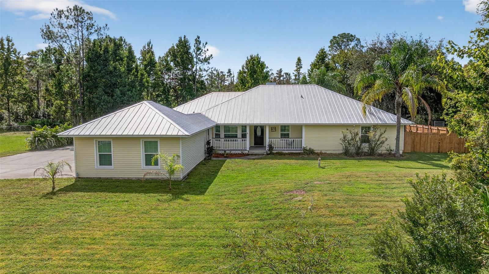 Welcome To Your Private Florida Estate At 26530 Green Willow Run In Wesley Chapel! Nestled On Just Over 2.04 Acres In The Highly Desirable Quail Hollow Pines Community, This Custom Built Home Offers 2,448 Square Feet Of Refined Living Space With 3 Bedrooms, 2.5 Bathrooms, A Den/Flex Space, Formal Living & Dining Rooms, And An Oversized 2-Car Garage. 
From The Moment You Arrive, You’ll Appreciate The Long Driveway, Mature Landscaping, and Tropical and Local Trees And Serene Setting That Combine The Peace Of Country Living With Easy Access To Shopping, Dining, Major Highways And Top-Rated Schools.
Step Inside To Find An Open Concept Living Space, Including A Formal Living And Dining Room Perfect For Entertaining, And A Spacious Family Room That Opens Directly To A Screened Pool Deck. The Kitchen Features New Quartz Countertops, A Breakfast Bar on the Center Island, Stainless-Steel Appliances,  Backsplash And A Sunny Daily Dining Nook Overlooking The Pool – Ideal For Everyday Living And Casual Gatherings.
A Dedicated Den/Flex Space With French Doors Opens To The Pool Deck – Perfect For A Home Office, Playroom Or Guest Retreat With Immediate Access To Outdoor Living.
The Expansive Primary Suite Is A True Retreat With Crown Molding, A Dual Faced Fire Place in the Primary Suite and Primary Bath, A Large Walk-In Closet And A Spa-Style En-suite Bathroom Featuring Dual Vanities, Granite Counters, A Soaking Tub, And An Oversized Walk-In Shower With Multiple Shower Jets. This Truly Split Floorplan Features Two Additional Bedrooms And A Hall Bathroom.
Outside, The Expansive Screened Lanai And Sparkling Gunite Pool With Waterfall Provide The Ultimate Florida Outdoor Oasis — Ideal For Relaxing, Entertaining Or Simply Enjoying The Peaceful Setting. The Fully Fenced Yard Offers Generous Space For Pets, Gardening Or Future Expansion. 
Notable Features Include: Brand New Air Conditioning, Roof Replacement with Metal Roof (2017) And Pool Re-Marcited (2019), New Well Bladder (2021), Kinetco Water Filtration System — All With No HOA, No CDD, And No Deed Restrictions. This Is A Rare Opportunity To Own A Custom Pool Home With Acreage In One Of Wesley Chapel’s Most Sought-After Neighborhoods. Experience The Perfect Blend Of Luxury, Privacy And Convenience — Schedule Your Private Tour Today!