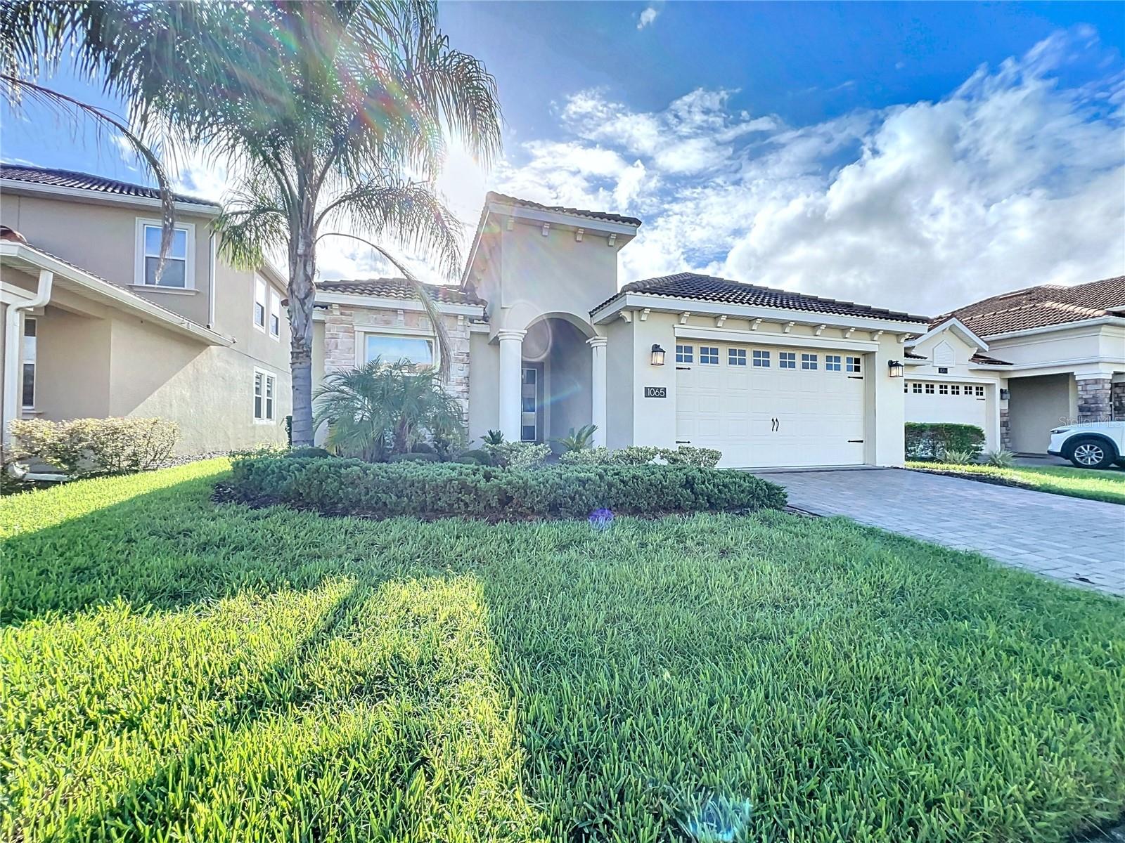Check out this magnificent 4-bedroom 2-bath home in the much sought after Champions Gate County Club. This inviting one story tile roof home has no rear neighbors and features a peaceful view of the conservation area that's part of the Champions Gate County Club golf course. It features an open floor plan and an impressive kitchen with 42' cabinets, quartz countertops, stainless steel appliances and a large island bar. The kitchen overlooks the expansive combination family and dining room that boasts beautiful tile flooring and creates a warm and inviting atmosphere while offering lovely views of the conservation area. The master suite has his and hers walk in closets and sliding glass doors that lead to the lanai and an over-sized bathroom with dual sinks, a walk-in shower and large garden tub. Additional features include an interior laundry room, covered rear patio and a two-car garage.... Champions Gate has unparalleled amenities that include a resort style pools, spa, fitness center, tennis, pickleball, basketball, golf, fitness center, on site concierge, and much more. The HOA fee includes cable, internet, lawn care as well as a $75 per month food credit at the private Plaza Club! Located just minutes from all the major theme parks and attractions as well as shopping, dining and major highways. Don’t miss this fantastic opportunity!