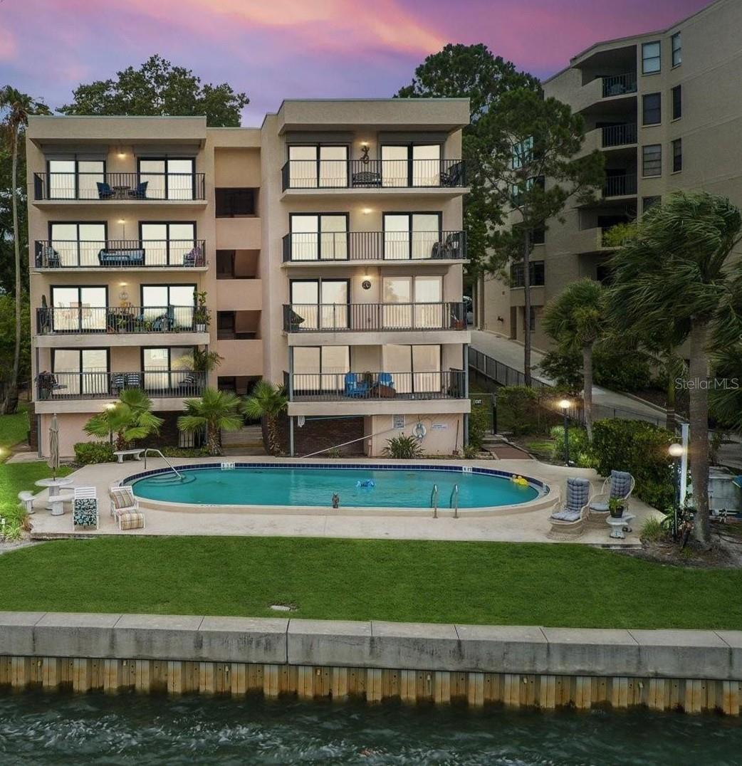 AVAILABLE OCTOBER 1ST! Welcome to this beautifully updated condo with an incredible view of the intercoastal waterways. This 2 bed/2 bath immaculate condo is very spacious with amazing views of Clearwater Harbor. You will appreciate living in this quaint mid-rise building as there are only 8 total resident units. This gorgeous condo has been recently renovated to include plantation shutters, an open kitchen with beautifully updated granite countertops, bright cabinetry and stainless steel appliances. As you walk through the spacious living room, step out on your patio for a morning cup of coffee and truly take in all of the beauty the Intracoastal has to offer. Walk down the hall and you'll find in unit laundry for your convenience. Both bedrooms feature walk-in closets, ceiling fans, and the perfect amount of space to rest and relax. The primary bedroom features an updated en-suite bathroom with a beautiful granite countertop and a walk-in shower. There is a carport offering one dedicated covered parking space along with additional guest parking spots, perfect for having guests over. Enjoy a sunny day at the waterfront, community pool. Take a dip, soak up the sun, and enjoy the view of the boats, jet skis, and even PIRATE ships cruising by. Conveniently located near renowned restaurants, shopping centers, major roadways, and access to Court St connecting you directly to the Causeway for easy beach access. Come rest, relax and enjoy the Florida lifestyle right here!