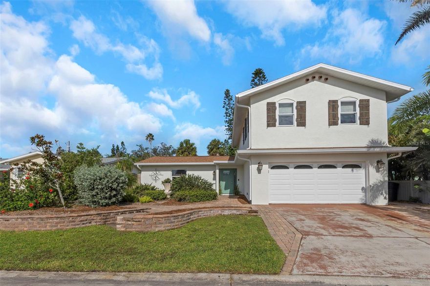 Located in Gulfport’s desirable Marina District, this spacious and well-maintained home offers over 2,200 heated square feet and a flexible floor plan designed for both everyday living and entertaining. Just a short walk to Clam Bayou Nature Park and downtown Gulfport’s popular shops, galleries, and restaurants, the home combines comfort, function, and an exceptional location.

A gracious foyer with a curved staircase and custom recessed wall niche creates a welcoming first impression. From there, your eye is immediately drawn to the heart of the home—the beautifully updated kitchen, centrally positioned and thoughtfully designed so that all main living spaces flow around it. Featuring a center island, quartz countertops, breakfast bar, and an exceptionally large pass-through pantry, this kitchen is as practical as it is striking and truly anchors the home.

Adjacent to the kitchen is a spacious dining area overlooking the backyard—ideal for casual meals or everyday gatherings—while a separate formal dining room shares the living space, offering flexibility for both relaxed and formal entertaining. The generous living room features built-in cabinetry and connects seamlessly to the dining area, creating an open yet well-defined main living level.
The first floor also includes a full guest bathroom and a bedroom with en suite bath, making it ideal for guests, extended family, or multigenerational living.

Designed with outdoor living in mind, the downstairs living space opens to a large covered, screened-in lanai with elegant arches, adding approximately 300 square feet of additional covered outdoor living space. This inviting area functions like an outdoor living room—perfect for lounging, entertaining, or enjoying Gulfport’s coastal breezes. Beyond the lanai, an expansive open patio provides ample room for dining and seating areas, creating a true entertainer’s backyard with space to gather, relax, and host memorable get-togethers, with plenty of room to add a pool.

Upstairs, the primary suite features a beautifully renovated bathroom and a large walk-in closet, along with a dedicated laundry room conveniently located just off the bedroom. Additional spaces include a built-in library, a fully functional office with wet bar, a third bedroom, and a bonus room that can serve as a den, home gym, or additional sleeping area—offering remarkable versatility.
Additional features include recessed lighting, skylights, impact-rated exterior doors and upstairs windows, hurricane shutters, high-velocity wind-rated fencing, and a two-car garage with an air-conditioned workshop, extra storage, and a ceiling lift for moving heavy items to the second floor. The exterior has been freshly painted, and the landscaped yard is maintained by a drip irrigation system with well pump and timer.

This is your opportunity to live in one of Gulfport’s most sought-after neighborhoods—a community known for its artsy, eclectic, and welcoming atmosphere. From waterfront sunsets and festivals in the park to exceptional dining and local boutiques, Gulfport offers a lifestyle that is both vibrant and distinctly its own.