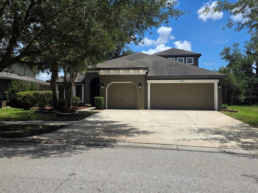 Four bedrooms, 3.5 bathrooms, a bonus room, a home office, and no backyard neighbors! Double doors open to a spacious entry with a flex space/formal dining room on the left, currently being used as a second home office, and a large breakfast area and kitchen on the right. High ceilings carry through to the primary living area, and the home features a triple split floor plan with stairs leading to the second floor. The primary bedroom suite is privately situated on the left side of the home and offers lanai access along with a spacious bath and walk-in closet. Across the living room are two additional bedrooms and a full bathroom. The kitchen overlooks the main living area and provides convenient access to the garage and laundry room while featuring stainless steel appliances, stone countertops, and a walk-in pantry with generous prep and storage space. Just beyond the stairs is the fourth bedroom, currently used as a home office, along with the laundry room and half bath. Upstairs includes a large bonus room, fifth bedroom with walk-in closet, and an additional full bathroom, offering flexible living arrangements and functional separation of space. Triple sliders open to a fenced backyard with passionfruit vines, mature trees, green space views, and private access to a walking trail. The covered lanai is pre-plumbed for a future outdoor kitchen. Additional features include a three-car garage, community amenities, and a playground located across the street. Seller is willing to assist with closing costs with an acceptable offer. Schedule your private showing today!