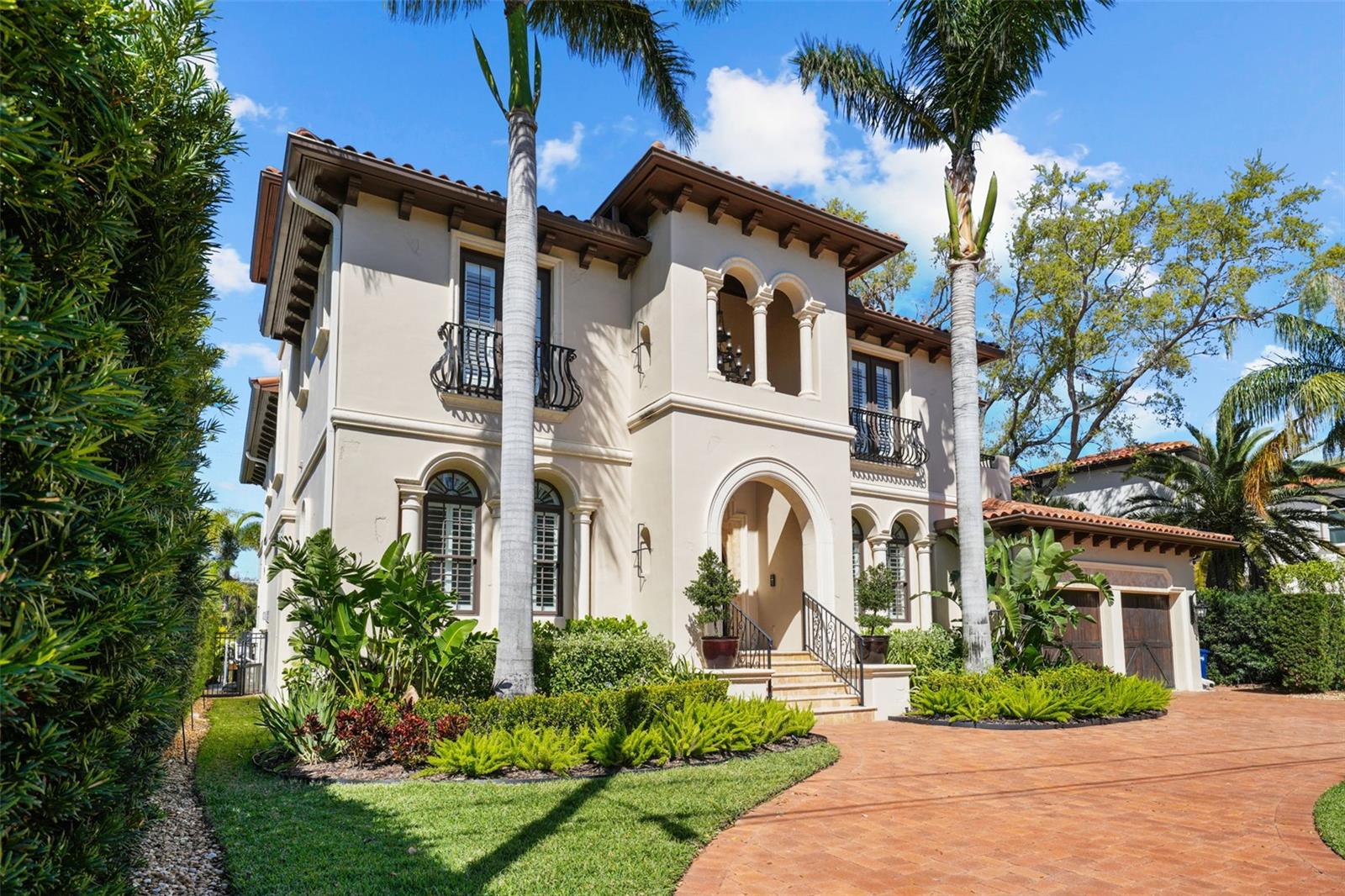 Beautiful Mediterranean style, custom Boss and Mennie home on coveted Davis Island. This stunning, move in ready home is on a wide deep water canal with two electric lifts and is a short boat ride to the open bay. This beautiful and functional floor plan features just shy of 6,300 heated square feet with 4 generous bedrooms and 5 full and 2 half baths. Upon walking in the stunning double door arched entry, you will find an expansive and open floor plan with a spacious recently updated master on the ground floor. The gourmet and recently updated kitchen is in the center of the home and features top of the line appliances, custom cabinets, a large Butler's pantry and features beautiful views of the water. This home is perfect for entertaining as the kitchen also overlooks the family room with gas fireplace and a climate controlled wine cellar. Also on the ground level, is a formal dining area, expansive storage/laundry room and a bonus room/office. The master retreat overlooks the backyard area with a sitting area, large walk in closet with custom shelving and a beautiful bathroom area with a jetted spa soaking tub and a multi-jetted spa shower that boasts water views from the expansive windows. Upstairs, you will find three ensuite and sizable bedrooms and a fully functional movie theater (could be made into 5th bedroom), Huge loft/game area, entertaining bar and French doors that lead out to a large back balcony area, perfect for relaxing or entertaining. The outdoor area features a pool, spa and firepit area as well as a side yard that has been turfed with enough area for a play set or outdoor activities. The home also features a 3 car garage and a large dock with one boat lift and two jet ski lifts. Bring your toys and start living the Islands lifestyle! Located on beautiful Davis Islands a short distance from the walking and bike path and just a short distance away from Davis Islands Village with many restaurants, shops, and bars. Bring your golf cart and enjoy the Island lifestyle with walking / biking paths, baseball fields, public tennis courts, public historic pool, two dog parks (one wet and one dry), a beach, public marina, and an airport. Located only minutes from Downtown Tampa, Water Street, Sparkman Wharf, and the Tampa Riverwalk, makes this neighborhood the most desired in South Tampa!