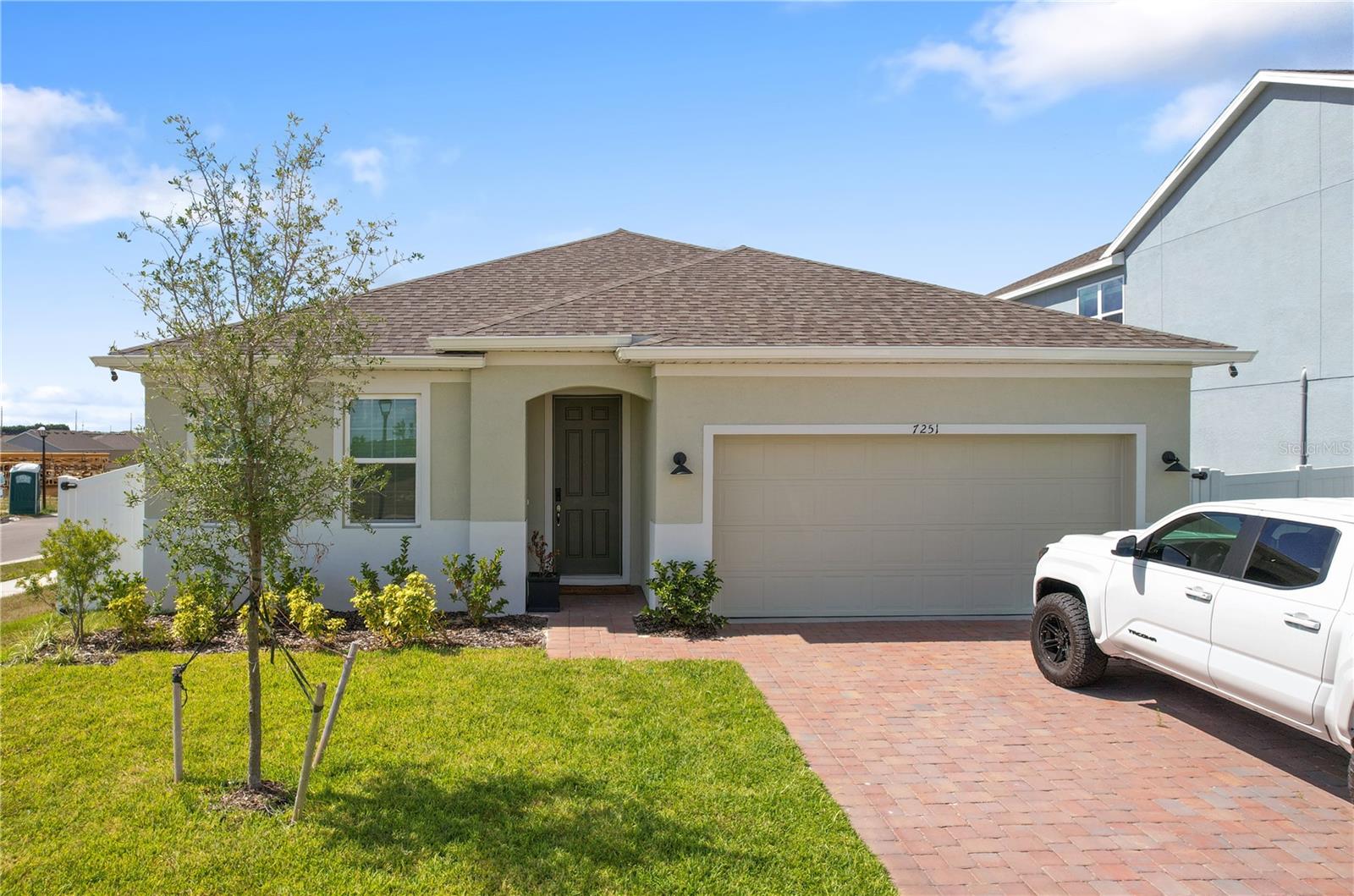 Welcome to 7251 Rolling Leaf Road—a beautifully maintained 4-bedroom, 2-bathroom Selby Flex Model built in 2024 by Landsea Homes, offering almost 1800 square feet of modern living space in the highly desirable Trinity Lakes community. This charming home sits proudly on a corner lot and boasts a fully fenced-in yard—perfect for outdoor entertaining, pets, or simply enjoying your private oasis. Step inside to discover elegant ceramic tile flooring flowing throughout the main living areas, complemented by plush neutral carpeting in all bedrooms for ultimate comfort. The open-concept kitchen is a chef’s dream, featuring gleaming granite countertops, stainless steel appliances, a large center island ideal for gatherings, and a walk-in pantry offering abundant storage. The spacious primary suite includes a luxurious en-suite bathroom with dual granite vanities, a walk-in shower, and a large walk-in closet. Bedrooms 2 through 4 are generously sized and share a beautifully appointed bathroom with dual sinks and granite counters. Residents of Trinity Lakes enjoy a wide array of community amenities including a resort-style pool with splash pad, clubhouse with state-of-the-art fitness center, soccer fields, playground, and a dog park. With its modern finishes, prime location, and unbeatable neighborhood features, this home offers the perfect blend of comfort, convenience, and community. Don't miss your opportunity to live in one of the area's most sought-after neighborhoods!