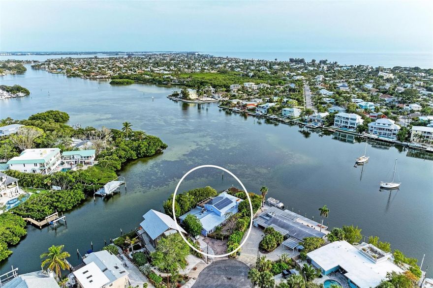 Tranquil, beautiful, relaxing, inviting, unique and full of life are just a few of the words that will come to mind when you walk into 511 South Drive in Anna Maria.  Once featured in SRQ magazine, this amazing 3 bedroom, 2.5 bathroom home at the very end of the street has 180 feet of water that gives you spectacular views of Bimini Bay and all it has to offer; the birds, the dolphins, the manatees and more. 511 South Drive sits on just over 20,000 sqft and is nestled at the end cap of the canal.  This unique home was completely remodeled in 2013 and transformed into what you see today.  You will feel its character the second you pull into the driveway and as you walk through the front gate into the courtyard full of plants, flowers, mature trees and a small pond with goldfish.  As you make your way to the back, you’ll fall in love with the views of the water and the wrap around wooden porch.  Make yourself cozy on either of the docks, one with a fully operational boat lift waiting for you to park your boat on when you come back from fishing or a sunset cruise.  Keep all your water toys and gear for fishing in your enclosed boat house! You can't help but notice the love and care that has been put into every room as you walk through the house.  The great room is wide open and ready for entertaining and family get-togethers.  The extra long island and counter space in the kitchen has room for all your chefs all at one time to create meals and still be part of the fun. The large pantry off the kitchen serves as a utility room as well as a laundry room that can be open or closed.  There is room for it all.  With French doors and massive windows along the walls in the great room, you won't miss a beat as the Florida wildlife shows up.  There are two bedrooms on the main floor with a Jack and Jill bathroom equipped with a shower and pedestal sink.  Both of these bedrooms open up to the front courtyard so you can easily step out for morning coffee or just enjoy the fresh air.  Just off these bedrooms is a large media room that can also serve as a second living room.  It's nice to have two areas in the home to have the option for some alone time or movie night.  Don’t miss the game room just off the media room!  With a full sized ping pong table and a table ready for a heated contest!  The half bath is in this hallway so it's easily accessible to the media room as well as the kitchen and great room.  The upstairs is exclusively the primary bedroom and bathroom.  The massive master bedroom has windows and french doors lining 3 of its walls so you can wake up to the incredible water views and spectacular sunrises and sunsets throughout the year.  Just off the primary bedroom is a very large woo that also overlooks Bimini Bay.  Soak up some sunshine, enjoy a cocktail or morning coffee with a view to die for.  The primary bathroom is upstairs as well.  With an oversized walk in shower as well as a beautiful clawfoot tub.  511 South Drive offers you all that Anna Maria Life has to give. Take a bike ride to the city pier for some live music or stop by one of the many shops and restaurants on Pine Ave.  Stroll down to the coveted and renowned beaches of the Gulf of Mexico and spend the day in the sand.  Your options are endless.  Come see your new home today!