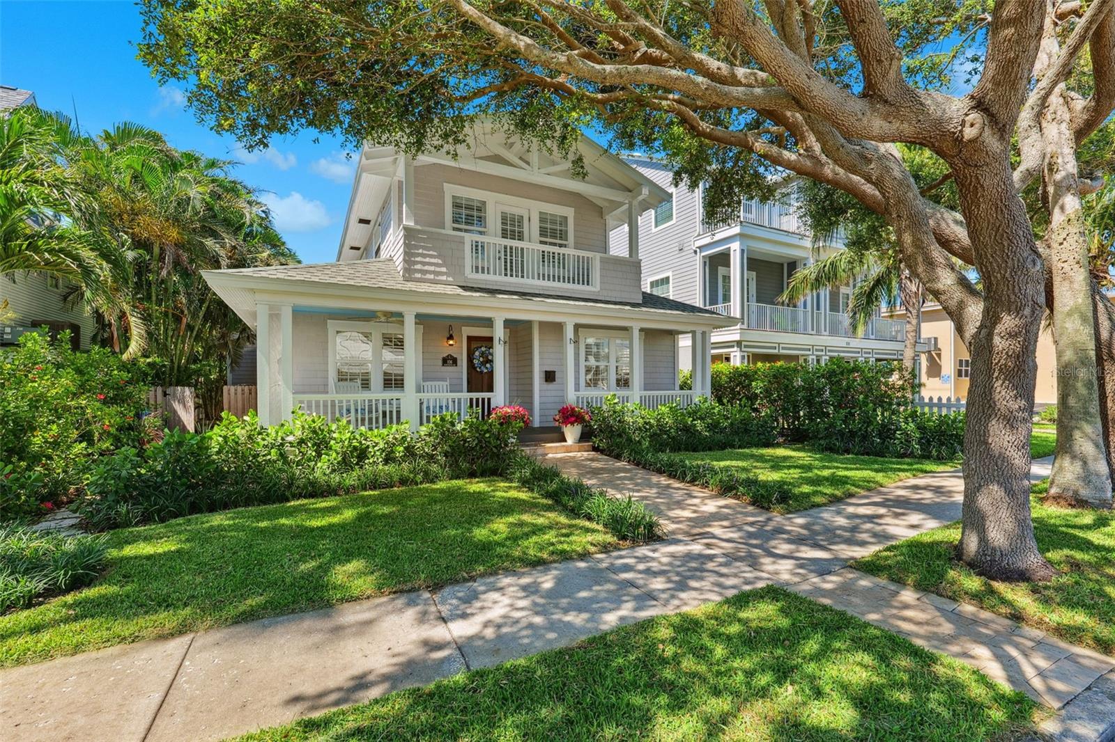 Welcome to your dream coastal getaway, now better than ever after a stunning remodel newly completed in 2025! Just two houses from the gorgeous sands of Pass A Grille Beach, this home combines the charm of Cape Cod style with easy, modern living. Step inside to find brand new hardwood floors throughout and a completely remodeled kitchen featuring light and bright coastal white cabinetry with beautiful quartz countertops, brand new stainless steel appliances including a natural gas cooktop—ideal for entertaining and creating your favorite recipes!
The main living area is a bright and inviting space highlighting a sunlit family room featuring a wall of floor-to-ceiling windows, a natural gas fireplace, and admiring your private backyard paradise. The backyard is perfect for relaxation, with a sparkling pool with a waterfall feature surrounded by a travertine deck and mature tropical palms—your own private oasis. The main floor also hosts an inviting spacious formal living room with built-in shelving as well as a large dining area offering plenty of space for meals and gatherings.
Upstairs, the primary suite is your personal retreat with high beamed ceilings, a spacious walk-in closet, an en-suite bath, and a balcony peeking out to the Gulf of Mexico. Downstairs, there’s another large bedroom with two closets, an updated bathroom, and a handy laundry area. Plus, there’s an oversized one-car garage with alley access and extra parking space. Additional updates include 2 brand new central air conditioning units, all new true hardwood flooring throughout the man living level, new washer and dryer and much more!
Living here means embracing the laid-back beach lifestyle. You’re just a short ride away from the boutiques and restaurants on 8th Avenue, with sunset golf cart rides being a perfect end to your day. Enjoy quick access to downtown St. Petersburg, just 15 minutes away, and Tampa International Airport within 40 minutes. This isn’t just a house—it’s your everyday vacation spot where you can move right in and soak up all the sunshine and sea breezes.