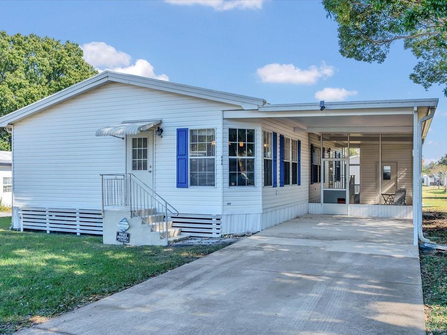 Step into comfortable, affordable living in this beautifully maintained home that's ready to welcome you from day one. The moment you arrive, you'll notice the pride of ownership—from the fresh exterior with charming blue shutters to the covered carport that offers both convenience and protection from the Florida elements. Inside, natural light pours throughout the open-concept living and dining areas, creating a warm and inviting atmosphere perfect for both everyday living and entertaining. The updated wood-look flooring in the kitchen and dining space adds a modern touch, while the kitchen island provides extra prep space and casual seating for morning coffee or quick meals. The spacious living room, with its vaulted ceilings and abundant natural light, offers plenty of room to relax and make it your own. Three comfortable bedrooms and two full bathrooms. The primary suite is a true retreat—spacious enough for a king-sized bed and featuring a generous walk-in closet and a private bathroom complete with both a refreshing shower and a relaxing garden tub. Practical touches abound, including an indoor laundry room with bonus storage space to keep everything organized. Outside, the screened lanai extends your living space, offering a perfect spot to enjoy your morning coffee. A storage shed provides even more convenience for lawn equipment or hobbies. Set on a lovely lot with a well-maintained lawn, this home is move-in ready and waiting for you to start your next chapter. Schedule your showing today!