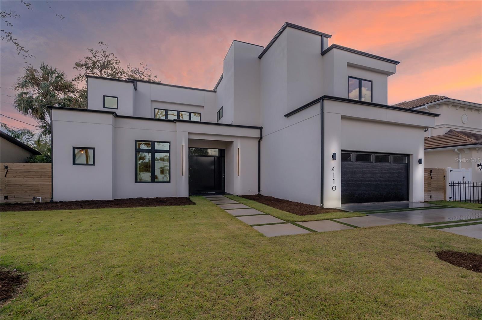 Welcome to your contemporary and inviting luxury residence in Swann Estates, Tampa, FL. This exceptional 2023-built home stands as a resilient modern fortress, having weathered recent hurricanes without any damage or flooding. The elegant property features 5 bedrooms and 6 bathrooms, offering 5,223 square feet of thoughtfully designed living space on a spacious 10,125 square foot homesite. The entry door, reminiscent of a bank vault, sets the tone for the secure and sophisticated lifestyle this home offers.
Step inside to discover the stunning cantilevered glass-clad staircase, a true centerpiece of the home. The open living area features a glass folding NanaWall, seamlessly connecting the interior to the expansive outdoor entertaining spaces. Here, you'll find a long, heated pool with in-pool bar seating, a spa, and a sunshelf/splashpad area, perfect for hosting gatherings or enjoying peaceful relaxation. There's even a sunken seating area where those not swimming can be part of the action at eye level of the swimmers!
The kitchen is equipped with modern conveniences Wolf and Sub-Zero, custom Italian Cabinetry including a sleek drawer microwave, the home is kept comfortable year-round with ultra-efficient air conditioning. The exterior boasts fresh tropical landscaping, xeriscaping, and native grasses, complemented by turf in the back and side yards for easy maintenance.
Safety and resilience are paramount, with all glazed openings being hurricane impact and safety rated, bringing you an insurance discount, safety and noise reduction. The home is equipped with a natural gas whole-home generator, dual tankless water heaters, and dual laundry facilities on the main floor and upper floor for ultimate convenience.
The master bath is a sanctuary of luxury, aspiring to the elegance of an Aveda spa. Complete with backlit mirrors and an option to have natural light come in at the touch of a button to raise the privacy shades.
This residence is not only high and dry, situated outside the required flood insurance zone X. This residence embodies the pinnacle of modern design and functionality. Welcome home to a life of elegance and smart living. Call for a private showing today!