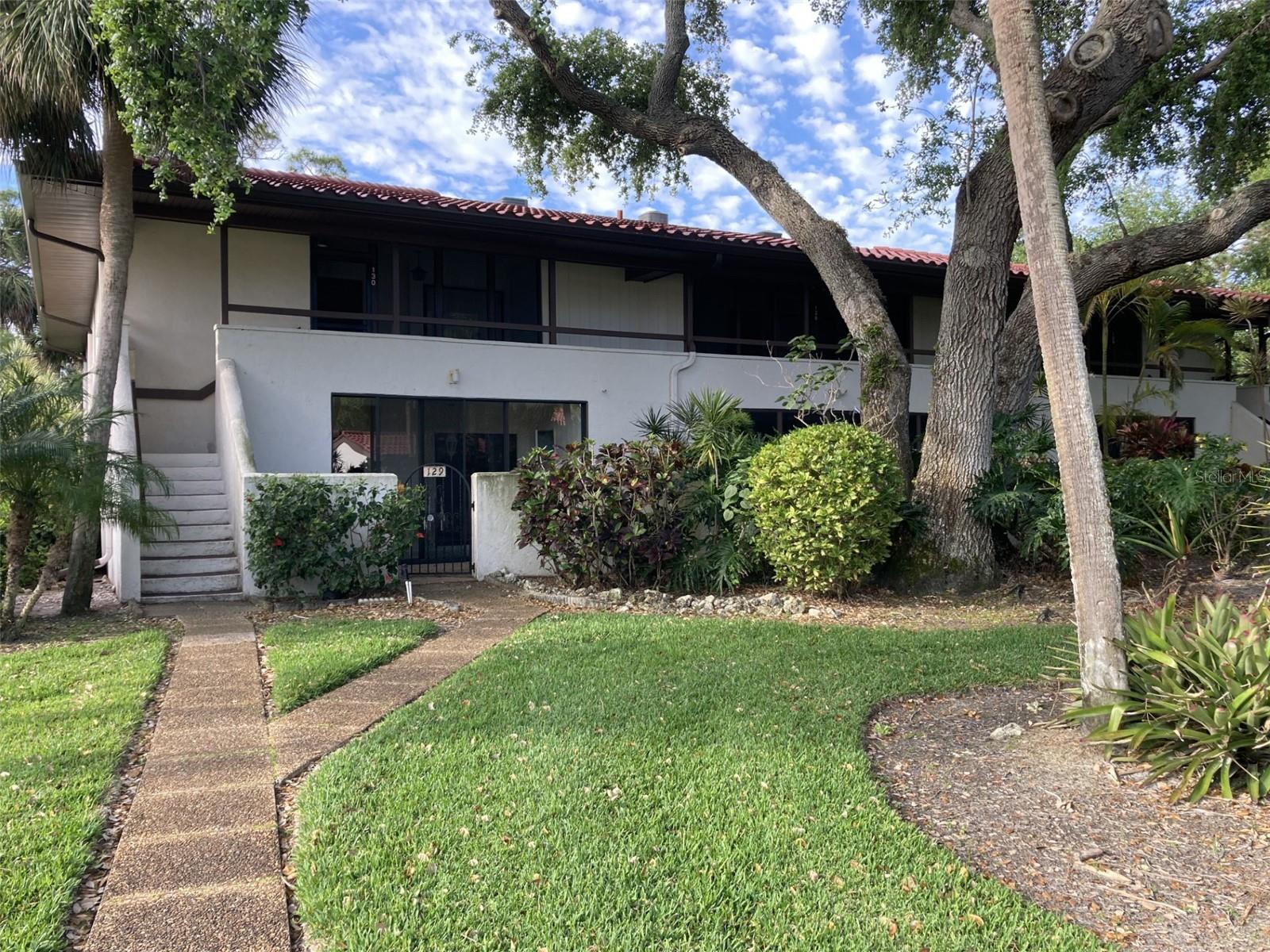 This is a first floor corner two bedroom-two bath condo in beautiful Valencia. Light and bright with windows in living room, dining area and kitchen. The rear lanai is glass enclosed with tile floors and beautiful views of mature landscaping and trees and close proximity to pool. There is also a front glass enclosed lanai with tile floors with large laundry room and storage closet. There is a front courtyard - decorate as you like! The walls have just been painted. Valencia is located within the IMG Country Club area featuring an 18 hole regulation golf course, which is semi-private. The country club also has a beautiful clubhouse with a grill room and large dining area overlooking Sarasota Bay. Close to shopping and restaurants, about 15 minutes to the airport and Sarasota. The parkway takes you directly to Cortez Rd which takes you to the beach - about eight miles.