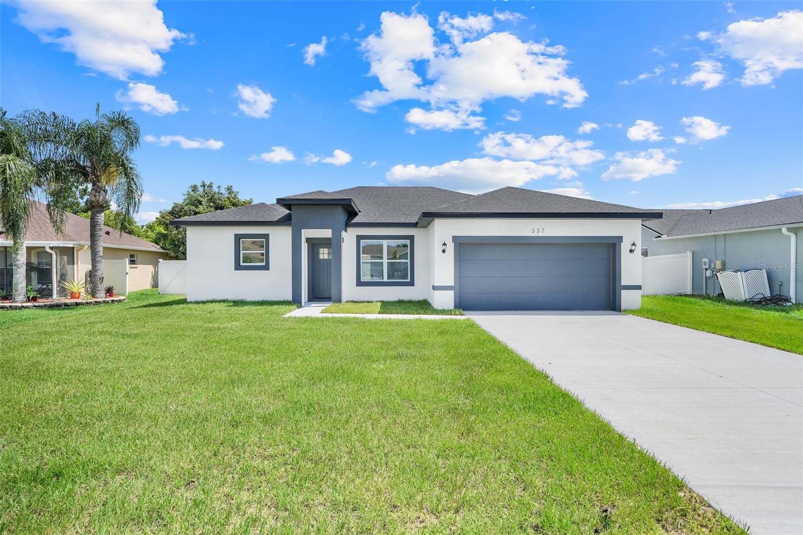Inquire about DOWN PAYMENT ASSISTANCE. Stunning NEW-CONSTRUCTION home. 4 bedrooms, 2.5 bathrooms. This home blends clean modern style with practical comfort. Bright kitchen with stone countertops, stainless appliances, wall mounted faucet over the oven, and a large island perfect for entertaining. Spacious primary suite with DUAL WALK-IN CLOSETS and a luxurious en-suite bath with big shower, soaking tub and double vanity. OVERSIZE BACKYARD with plenty of room for a pool, garden, or play area. Two-car garage, finished EPOXY floor. Closable laundry room. HALF-BATH next to kitchen. Great LOCATION right off Marigold Ave and Cypress Pkwy, minutes away form Poinciana Pkwy, close to schools and shopping.
