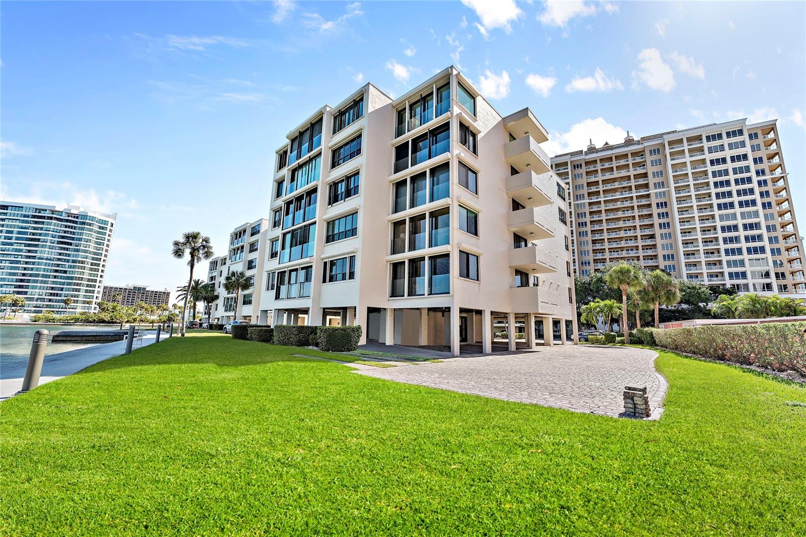 Welcome to Lawrence Pointe, a boutique community designed by Sarasota School of Architecture's own Tim Seibert. Lawrence Point boasts some of the best unobstructed views of Sarasota Bay and the Ringling bridge, with only forty units among three low rise buildings for ultra private living! This Penthouse apartment has been luxuriously renovated in 2020 to maximize your interior space, providing 2309 square feet of luxury, with 3 bedrooms, 2 full bathrooms and 2 outdoor balconies. The open floor plan welcomes you with bright sunny light, floor-to-ceiling views of Sarasota Bay and a gorgeous chef’s kitchen. Highlights of this complete custom renovation by Markley Construction & Development include, all new hurricane impact windows and sliding doors, new pvc piping (no Cast Iron), all new electrical, new ductwork, new plumbing, hardwood Bamboo flooring, custom kitchen cabinetry by Campbell Kitchens, Miele Cafe Series Appliances, Liebherr Refrigerator & Freezer, 2 full bathrooms with Marble showers, custom closets in all three bedrooms.
The pet-friendly community grounds have a clubhouse and an over-sized pool overlooking the Bay and is conveniently located amid all the activity Downtown, adjacent to the Ritz Carlton Hotel, minutes to Marina Jacks and countless restaurants and nightlife. Don’t wait 2-3 years for a new build, you can own and live Downtown now!