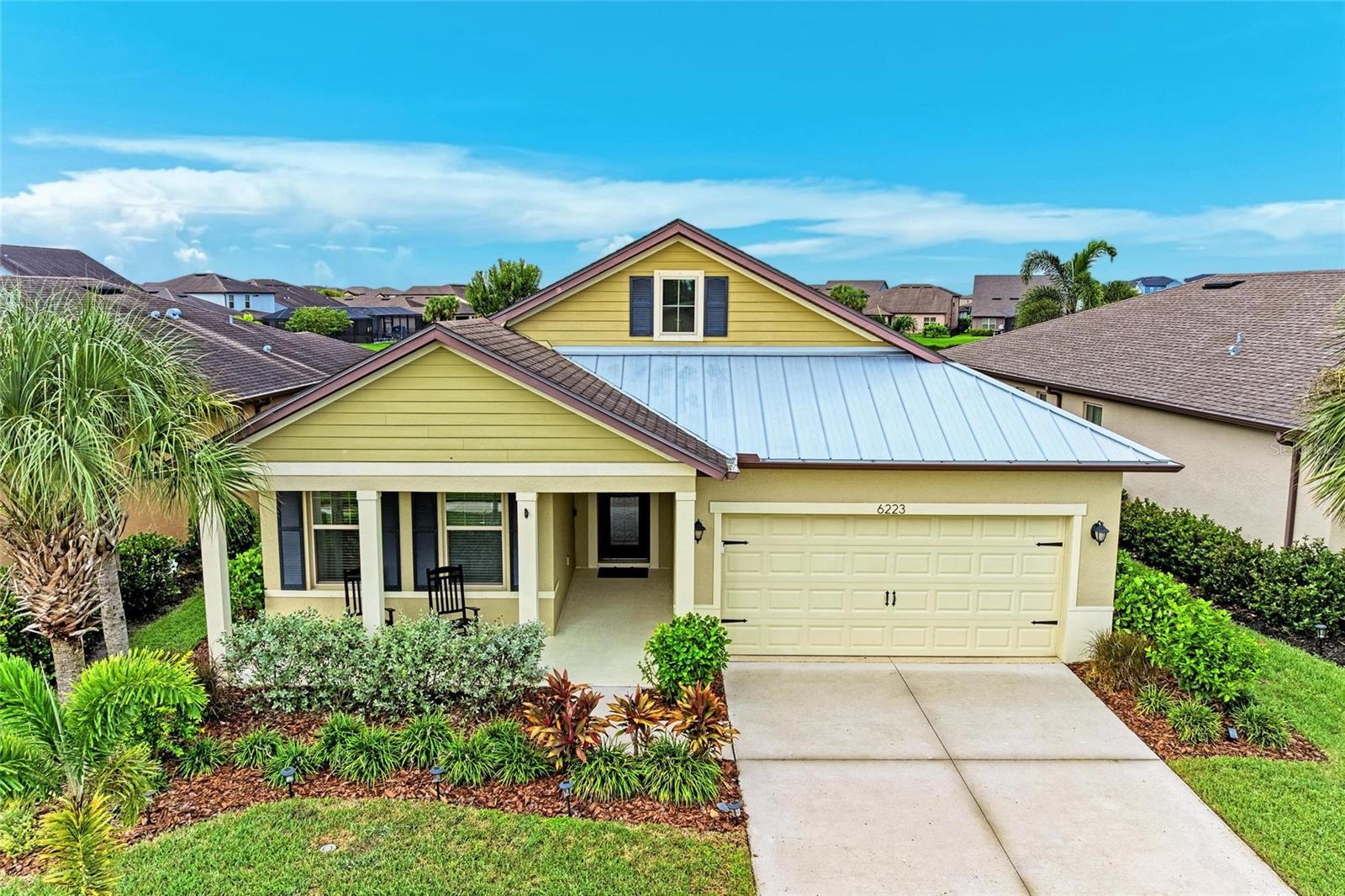 Welcome to this stunning 2 bedroom, 2 bathroom home with a spacious den in the highly sought-after community of Trevesta. The den is generously sized and can easily be converted into a third bedroom, offering flexibility to fit your needs. From the moment you arrive, you’ll be impressed by the home’s curb appeal with its large covered front porch, decorative metal accent roof, and custom glass front door. Step inside to a light-filled, open layout featuring beautiful laminate flooring throughout the main living area. The gourmet kitchen is a true showpiece with stainless steel appliances, a built-in oven, hood vent, quartz countertops, under-cabinet lighting, pendant lights, and a cozy eat-in area. Flowing seamlessly into the great room, this space is perfect for both everyday living and entertaining. The master suite is a private retreat with a spacious walk-in closet and an en suite bathroom featuring dual sinks, quartz countertops, and a walk-in tiled shower. The thoughtfully designed laundry room includes custom cabinets, shelving, and charming shiplap accents. Step outside to enjoy your screened lanai overlooking serene water views—perfect for enjoying sunsets. The fenced yard is ideal for pets, with close picket spacing for small dogs and taller fencing for larger ones. Additional highlights include a 2.5-car garage with epoxy flooring, offering ample room for a golf cart, larger vehicles, or even a small boat. Living in Trevesta means access to resort-style amenities: a zero/beach-entry pool with cabanas, splash pad, playground, 5,600 sq. ft. clubhouse with on-site management, 24-hour fitness center, covered outdoor entertaining areas, and scenic lakeside walking and jogging trails. HOA fees also cover basic cable, internet, and irrigation, giving you even more value. Perfectly located near major highways, this community provides quick access to world-famous beaches, St. Petersburg, Tampa, Bradenton, Lakewood Ranch, and Sarasota. This home blends practical features with elegant finishes, offering the ideal setting to create lasting memories. Don’t miss your chance—schedule a private tour today!