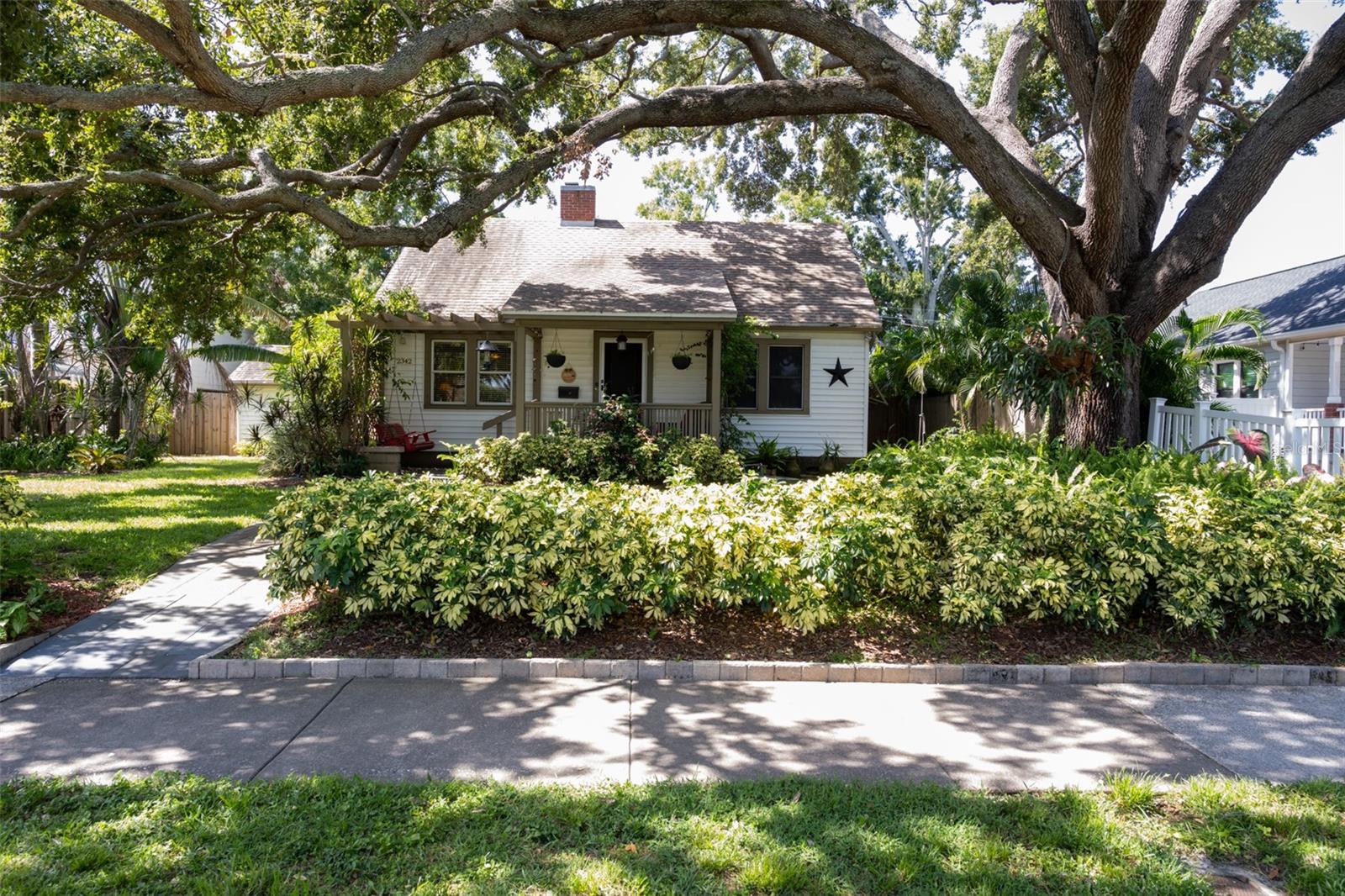 Historic Charm Meets Modern Functionality in the Heart of Kenwood
Welcome to 2342 8th Avenue North, a beautifully preserved and thoughtfully updated home in the highly sought-after Historic Kenwood neighborhood of St. Petersburg. This rare gem blends the character of the 1940s with modern conveniences, offering a perfect balance of timeless craftsmanship and functional living.
Inside, you’ll find three bedrooms and two bathrooms, including a spacious primary suite featuring a private en suite bath, independent A/C system for personalized climate control, and elegant French doors that open directly to the lush backyard oasis—ideal for relaxing mornings or quiet evenings outdoors.
The home is adorned with original 1940 hardwood flooring throughout the main living areas, historic glass and brass doorknobs, and vintage bathroom tile that nods to the home’s architectural roots. Metal hurricane shutters provide added peace of mind and protection.
Functionality meets flexibility with a gas-connected infrastructure serving the kitchen, laundry, tankless water heater, whole-home generator, outdoor grill, and even additional hose bibs for expansion possibilities. These features are a rare find in historic homes and provide incredible utility and efficiency.
Step outside into your own private sanctuary—a truly stunning backyard framed by mature oak trees, lush tropical landscaping, and designed with entertaining in mind. The space provides a unique escape from the city, perfect for hosting gatherings, enjoying outdoor dining, or simply unwinding in nature.
Alley access leads to a private driveway and a covered carport with room for two vehicles, enhancing both convenience and privacy.
Located just minutes from downtown St. Petersburg, the Grand Central District, local art galleries, award-winning restaurants, and vibrant community events, this home places you in one of the most dynamic and connected neighborhoods in the city—all while offering a peaceful retreat of your own.
If you're searching for a home with authentic character, modern amenities, and unbeatable location, 2342 8th Avenue North is not to be missed.