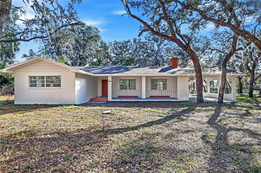 ***BRAND NEW ROOF WILL BE INSTALLED AT CLOSING***
MODERN LUXURY meets timeless Old FLORIDA CHARM beneath a canopy of mature oak trees draped in Spanish moss. This BEAUTIFULLY REMODELED home sits on a rare OVERSIZED HOMESITE of over 1/3 acre, offering shade, privacy, and a peaceful natural setting.

Situated on a UNIQUE INSIDE-CURVE CORNER LOT, the property features a CIRCULAR DRIVEWAY and DRIVE-THROUGH CARPORT IN A PORTE-COCHÈRE DESIGN, connected to the entrance by a long COVERED FRONT PORCH.

Inside, the home showcases a BRIGHT OPEN-CONCEPT LAYOUT with large PORCELAIN TILE FLOORING throughout. The BRAND-NEW DESIGNER KITCHEN features shaker cabinetry, stainless steel appliances, modern lighting, and a stunning QUARTZ WATERFALL ISLAND that anchors the living space. The spacious living room is highlighted by a charming BRICK FIREPLACE.

Both bathrooms have been BEAUTIFULLY UPDATED with SPA-STYLE TILE SHOWERS, QUARTZ VANITIES, and MODERN FIXTURES. The home also offers 3 SEPARATE ENTRANCES, creating flexibility for a home office, guest suite, or multi-generational living.

With a NEWER AC, a BRAND NEW ROOF installed prior to closing, NEW KITCHEN, BATHROOM, FLOORING, FRESH PAINT, and NO HOA. this TURNKEY PROPERTY offers both COMFORT & FREEDOM.

Conveniently located near State Rd 50 (Cortez Blvd) with direct access toward Orlando, the home is also minutes from I-75, the famous Withlacoochee State Trail, and Cypress Lake Preserve — perfect for nature lovers and outdoor enthusiasts.

Schedule your private showing today!