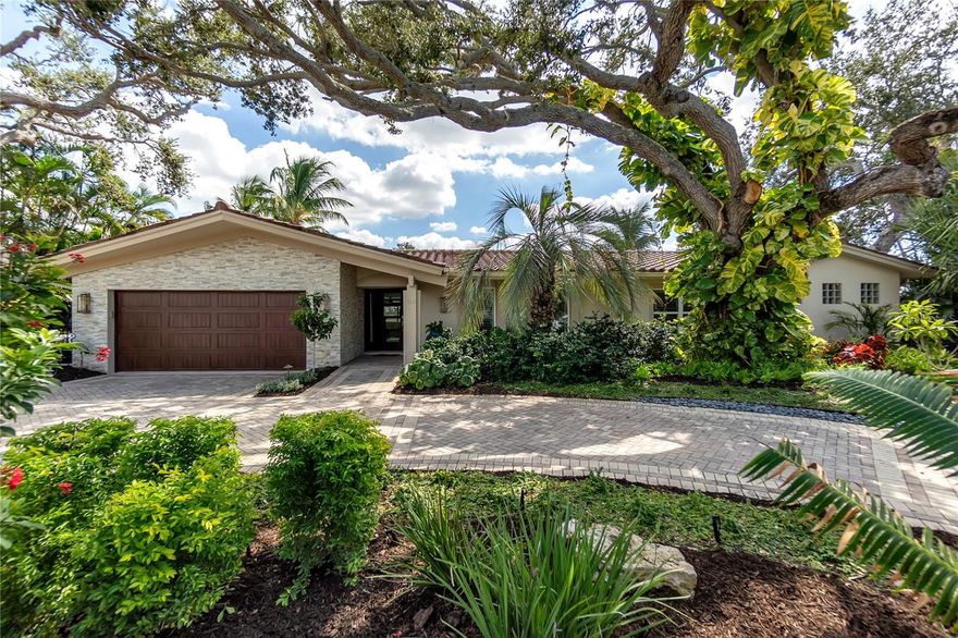 ELEGANT SIESTA KEY WATERFRONT RETREAT - Welcome to a truly distinguished canal-front residence, where timeless design meets the effortless beauty of waterfront living. Set beneath majestic oaks and tropical landscaping, the canopied circular paver driveway greets you. This exquisite pool home offers privacy, sophistication and an extraordinary outdoor lifestyle. An avid boater's dream with 110 feet of water frontage, a 16K LB. boat lift and a double jet-ski lift. Light and bright, neutral colors and tile flooring flow throughout the home. The main living areas include a large great room surrounded by windows and flooded with natural light which frame peaceful tropical water views and the outdoor living area. Separate living room, den or game room and formal dining room offer an open layout and flexible floorplan which allows you to personalize your living space for your lifestyle. Fabulous cook's kitchen is open to great room and nicely updated with solid wood cabinetry, stone countertops and backsplash, stainless appliances with gas range, large wine cooler and pantry. Custom butler's pantry added for convenience and large laundry room with storage cabinets galore. The owner's retreat is spacious and serene, offering tropical views of the pool and waterfront along with private lanai access. It features a generous walk-in closet and a beautifully updated bath with sleek stone countertops, dual sinks and a tranquil walk-in shower illuminated by soft, filtered light through the glass block windows. Two private guest en suites are thoughtfully positioned in separate wings, each offering its own beautifully updated bath. Relax and sip a cool drink on your sunny lanai and observe manatees or fish right off your own dock. Watch fish at night with new underwater snook light. Enjoy gorgeous pool area with wide intersecting canal views and remote controlled fire pit and tiki torches, wonderful for entertaining friends and family. Coastal living at its best!  A quick 7-minute access to the intercoastal waterway and Roberts Bay. Just a short bike ride to world-famous Siesta Key Beach and The Village. Enjoy swimming, boating, fishing, kayaking, fine dining and all the comforts of living in paradise. Newer top of the line sea wall with cap and 5x50 foot dock complete with water and electric. Appreciate the safety and security that a Generac whole house generator and hurricane windows, doors and garage door offer. Too many upgrades to list including: Custom interior window shutters, newer breaker box panel, well system for irrigation, new pool heater and pool pumps, outdoor fridge, ice maker, storage shed, 2 under the counter ice makers, no grass (maintenance free) landscape, utility sink and cabinetry in garage. The perfect property for year-round living, a second home or investment as an Island getaway. Truly a unique home that lives well with a great vibe! Nestled on a private cul-de-sac street experiencing significant luxury redevelopment! A rare opportunity and great value for the most discriminating buyer seeking the ultimate Florida lifestyle.