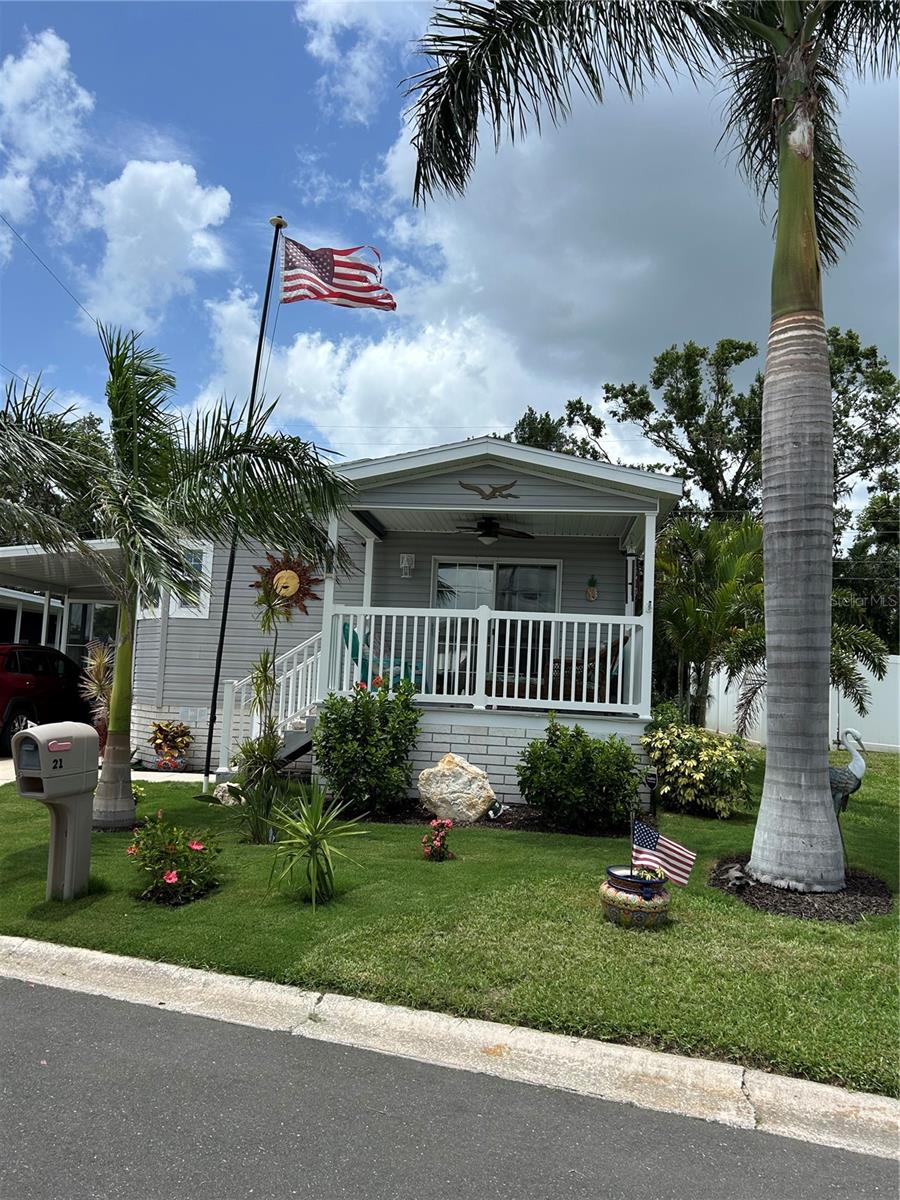 Gorgeous Premier Skyline 2017 home that comes with a home warranty good until Oct. 19, 2030!! No need to worry about the A/C, electric, plumbing, appliances with this transferable, home warranty. This is a two-bedroom, two full bath open concept home lovingly cared for. Includes a fully enclosed Lanai, under A/C and heat with ceiling fan and double paned windows. Windows in (11’x17’) lanai are coated with sun/heat resistant Sun Shield window tinting. This is also on the front glass sliding doors in the living room. Insulated attached shed (11’x11’) off lanai with back door access to beautiful yard. Huge center island in kitchen with loads of storage! Living room has ceiling fan. Master bedroom has an oversized closet and ceiling fan. 2nd bedroom with ceiling fan, has lovely tropical view and no one lives behind this home! This home also has solar panels, paid for, that will save you so much on your electric bill! Past 6 months average bill was $55.81. Includes a tankless water heater that saves money! 1412 SF under air and heat. Beautiful 8’x12’ front porch with lake view and ceiling fan. Gorgeous stucco skirting that is solid with access to under the home. Beautiful landscaping with two self-pruning royal palms out front make it look very majestic! This home has never had any issues due to weather!! Not in a flood zone.
This is Leisure Lake 55+ Co-Op where you own a share of the Co-Op & $212/month covers: water, sewer, lawn maintenance, trash pickup and amenities. Amenities include pool, shuffleboard, pickle ball court, library and many activities such as dances, craft classes, exercise, and a full fitness center! This home is a must see!