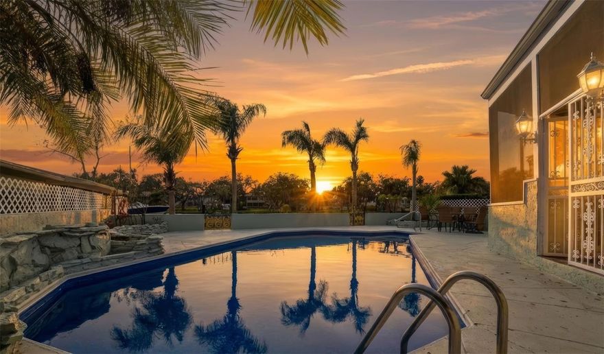 A rare waterfront estate where luxury meets freedom—set on a nearly one-acre double lot with approximately 160 feet of frontage on the Cotee River, offering direct access to the Gulf of Mexico. Private, elevated, and beautifully reimagined, this is one of  Downtown New Port Richey’s most exceptional hidden gems in this Golf Cart Friendly Community!
Inside, over 4,000 sq ft of light-filled living unfolds with soaring ceilings, expansive Andersen windows, porcelain tile throughout, and a striking wood-burning fireplace anchoring the main living space. The home was thoughtfully updated to feel both grand and inviting—perfect for entertaining or effortless everyday living.
The showpiece kitchen, fully renovated in 2024, is designed to impress with all-new appliances, generous workspace, and seamless flow into dining and living areas. Whether hosting intimate dinners or lively gatherings, this home was built for connection.
The layout offers flexibility and privacy, with four bedrooms on the main level and a true upstairs primary retreat. The primary suite features a spa-inspired marble bath and opens to a screened deck with sweeping views of the river, pool, and expansive fenced grounds—your personal escape above it all.
Step outside to over 2,000 sq ft of covered and screened veranda, overlooking a newly refinished saltwater pool, lush landscaping, and tranquil waterfront. From sunset swims to dockside mornings, boating, fishing, or entertaining under the stars—this is Florida waterfront living at its finest. A private dock, RV pad with 50-amp hookup, workshop with electric, and wide rolling gate add both convenience and capability.
Major upgrades include Owens Corning shingle roof (2025), flat roof (2024), HVAC systems (2022), hot water heaters (2022), full interior paint, LED lighting, landscape lighting, updated baths, and more—all meticulously maintained. The home has never flooded and sits elevated above the river. No HOA.
Offered mostly furnished (excluding sentimental items) and in downtown New Port Richey, parks, beaches, and the upcoming Grand Blvd bridge & riverwalk, this is more than a home—it’s a lifestyle statement.