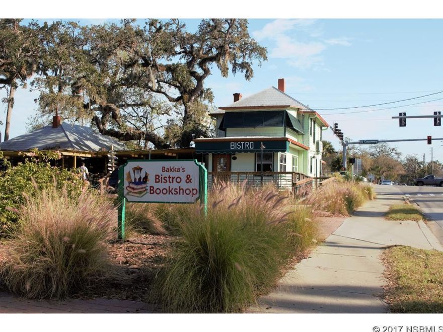 Under Contract and taking back up offers! Incredible high traffic location, steps to Canal Street, by the busiest intersection in New Smyrna Beach.  Sits beside South Bridge and accross the Street from Florida Hospital.  This high visibility commercial property has 25 + parking spaces. Both sides of the duplex in the back is rented - month to month tenancies.  Open a BBQ, or any restaurant, rent other sections out for additional income.  Fire pit attracts customers and tenants alike off of the Brazilian Mahogany deck (which will outlast all others). Great for offices, a residence plus business on site or any number of options.   A serene water fountain sits in the center of the property with gorgeous pergolas and soft lighting.  Lots of income potential in this highly sought after area.  French doors, wood floors, stained glass window(s) built ins and other quaint, ideal features throughout.  This is a MUST SEE to appreciate!