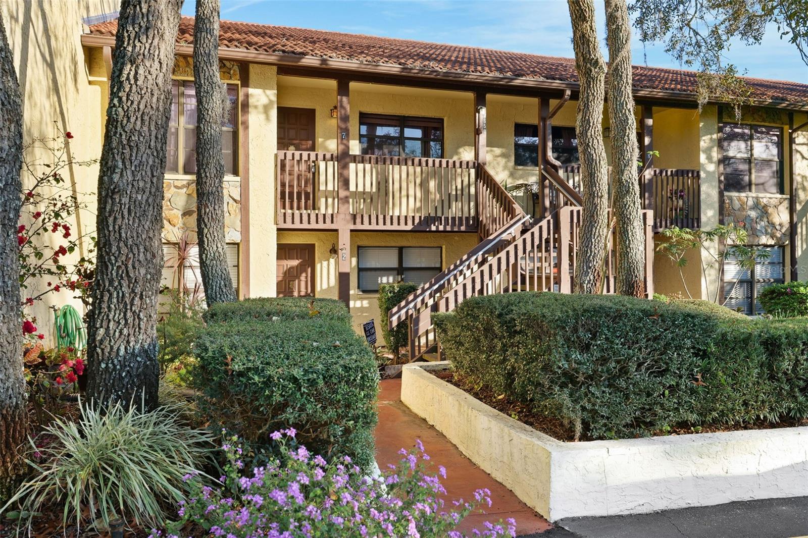 Welcome to Forest Lake Condos and this quiet upstairs corner unit featuring 2 bedrooms and 2 bathrooms. With extra windows, the home is filled with natural light, creating a bright and inviting atmosphere. The spacious living and dining area boasts luxury vinyl flooring and soaring vaulted ceilings, offering both comfort and style. A glass-enclosed balcony with screens provides the perfect spot to unwind and enjoy the peaceful setting. Washer and Dryer included and water paid for by the owner. The split-bedroom layout ensures privacy, with the guest room featuring its own bathroom with a tub, while the primary suite offers a private bath with a step-in shower. Reserved covered parking is included, along with ample guest parking. Forest Lake Condos offers wonderful community amenities, including a clubhouse with regular activities, a sparkling pool, and a fitness room. Conveniently located near shopping, dining, and easy freeway access, this home combines comfort, lifestyle, and convenience in one desirable package.