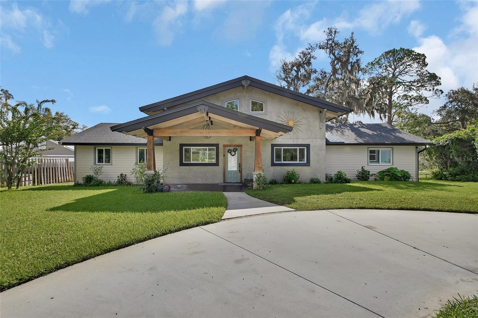 Tucked away on a peaceful, wooded lot, this custom 2021 craftsman-style home—rebuilt from the ground up—feels like a breath of fresh air. Secluded and serene, yet just minutes from downtown DeLand, Stetson University, and a quick drive to the beach, it offers the perfect balance of privacy and convenience.
Walk through the front door to panoramic lake views and the warm glow of natural wood ceilings that soar above.
The bright, open kitchen is perfectly set up with high-end stainless appliances, a gas range, and plenty of space to cook, gather, and share good food. Whether it’s coffee with a view or dinner with friends, this kitchen can handle it all.
The owner's suite is a true retreat. French doors open to a private deck overlooking the water, and the en-suite bathroom is spa-like—complete with a dreamy walk-in closet, a separate soaking tub, and a custom shower that makes every morning feel like a treat.
Guests are well cared for, too, with their own wing that includes another bedroom, full bath, and cozy sitting area with even more views of the lake.
Downstairs, a curved concrete staircase leads to a flexible third bedroom with its own entrance and plumbing in place for a future wet bar or kitchenette—think game room, guest suite, or even a rental opportunity.
Outside, the possibilities keep coming. There’s a 27’ x 40’ insulated garage rough plumbed for future water and septic—ideal for a workshop, studio, or space to stash your boat and toys. Under the house, a bonus room (currently used as a kennel) could easily become storage or a space for lake gear.
And the lake? It's right there. Fish off your private dock, launch a kayak at sunset, or just sit at the firepit with a glass of wine and listen to the breeze move through the trees.
This is more than a house—it’s a lifestyle. Relaxed, private, and beautifully connected to nature.