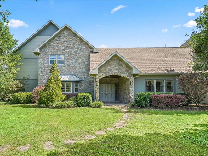 If you are looking for an exclusive neighborhood with private access to the Greenway, then look no further! Welcome to a property unlike any other. A grand custom home sitting in a premier location… The beautiful and private neighborhood of Equine Estates. As you pull in through the gates your eyes are immediately drawn to the grandness of this home. It makes a statement well before you enter. Upon entering however, you find that the classic beauty is carried along into the interior of the home as well. Light and open with touches of warm woodwork, this home fills you with a sense of timelessness and intrigue. You’ll find many great spaces throughout the home whether it is the large functional kitchen or the cozy seating areas. You may enjoy a game in the billiard room or a morning coffee on one of the balconies or even an evening cocktail on a serene enclosed lanai. You might like a peaceful ride on the private 3 mile horse trail around the community that also gives you private access to the Cross Florida Greenway. There is ample room for fun or relaxation beside the totally private, naturally inspired swimming pool or secret garden gazebo. You can work on your golf game with practice facilities built in which even include lighting for night sessions. Among the many areas to enjoy, let us not forget the expansive primary suite, set in a wing of the home separated from the guest quarters. Here you’ll find room enough for your own private seating area and balcony with perfect views. Spacious closets and a large bathroom complete with a luxurious jacuzzi style tub surrounded by natural yet artistic tile work. As you tour the home you’ll find the private office, gym, 2 full guest baths, plenty of storage, dual entry pantry, laundry, 4 car garage, and wet bar. You’ll notice that every bedroom features a walk in closet outfitted with custom shelving and each has its own private full bath. For the equine hobbyist, there is a well designed barn complete with four stalls, two temperate controlled wash racks, tack and storage rooms, 1/2 bath and large garage bay. The entire property is fenced with multiple paddocks. There is also an observance area complete with natural shade from the trees which have been pruned for just such an occasion. It is a truly peaceful setting among the elite of Ocala. This is not just a property to look at but a home to feel and experience. Connect with us to find out more. We would love to provide you with a private tour today.