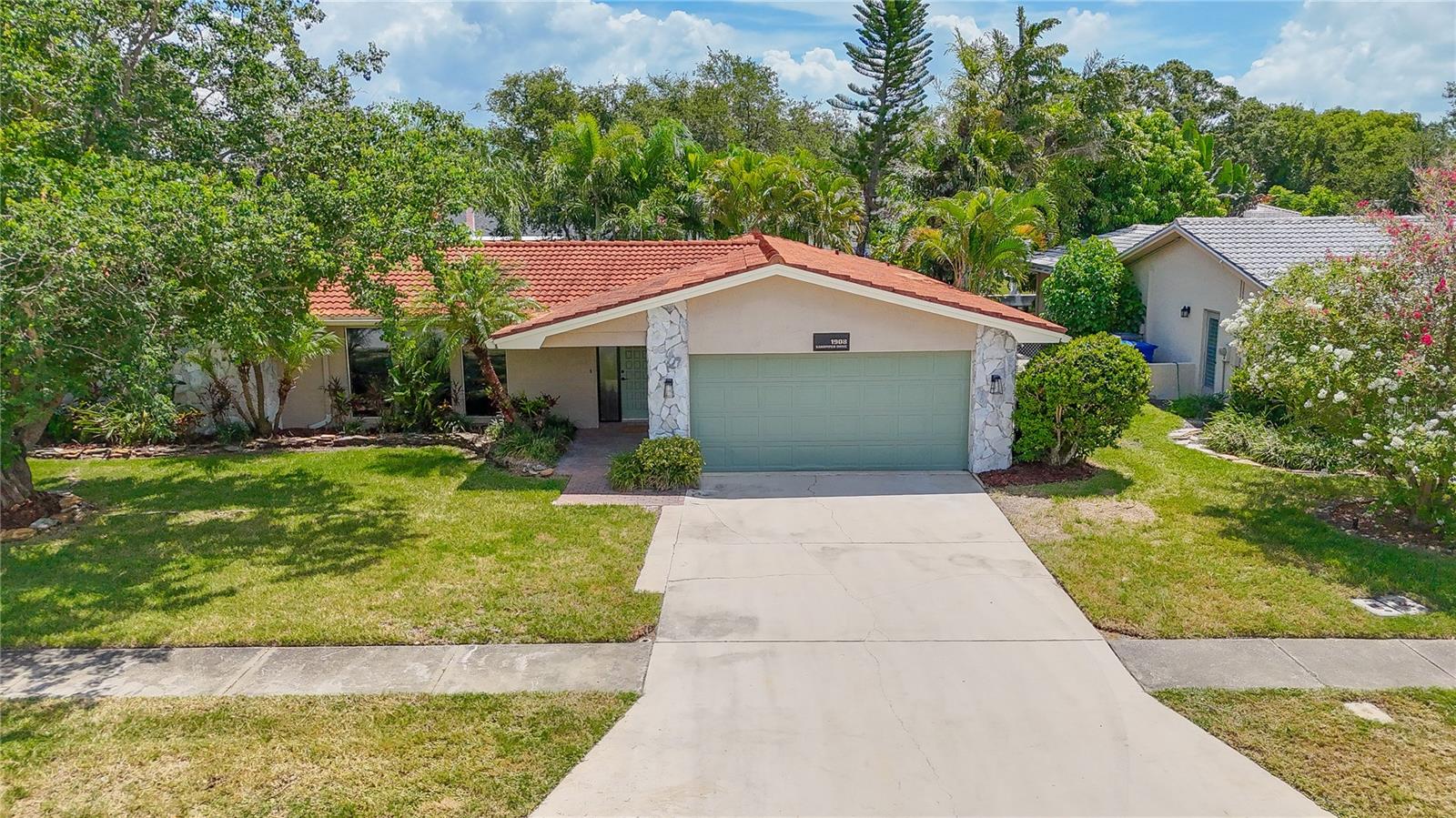 Rarely do you find a property that truly stops you in your tracks. This stunning and sprawling four bedroom waterfront home emits a gracious, elegant, and lasting impression. Ideally nestled in the sought after subdivision of El De Oro West, 1908 Sandpiper lays its claim with an impressive .33 acre lot alongside 80 linear ft of salt water canal frontage. Perfect for large families and multi-generational living alike, the tri-split bedroom floorplan and three separate and large living spaces offer endless arrangements, multiple entertaining spaces, and privacy alike. Dual Master bedrooms with one offering beautiful water vistas and the other a spa worthy en-suite, both with walk-in closets. This home has just undergone a complete and meticulous remodel including all new luxury vinyl plank flooring, 5 inch baseboards, high end lighting, and fresh interior paint throughout. The all new well equipped kitchen is central to the home and is a culinary dream. Adorned with level two Calcutta quartz countertops, soft close cabinetry, stainless steel appliances, butcher block floating shelving, and ample prep space. Open, light, and airy, the kitchen with pass-through, flows effortlessly from all three living spaces into a breakfast nook and dedicated dining room. A bonus room caters to your needs and can be used as a theater room, craft room, office, or even made into a 5th bedroom or third bath. Just beyond the dining room is a door that leads out to your professionally landscaped backyard oasis with a large composite patio overlooking the flowing water. A six zone irrigation system keeps your tropical plants and St Augustine grass thriving. Built to stand the test of time with solid all block construction, tile roof, newer seawall, and many newer double pane low emissivity windows including an impact rated overhead garage door. Live the Florida lifestyle with Kayak/small motor vessel access on Allen's creek with an array of game fish and marine life. Embark on a serene 45 minute paddle that winds along tropical flora and fauna guiding you all the way to the waters of Old Tampa Bay. This home's central location offers an easy drive to vibrant St. Petersburg, shopping, fine local fare, two international airports, championship caliber professional sports, and the world famous sugar sand beaches of the Gulf.