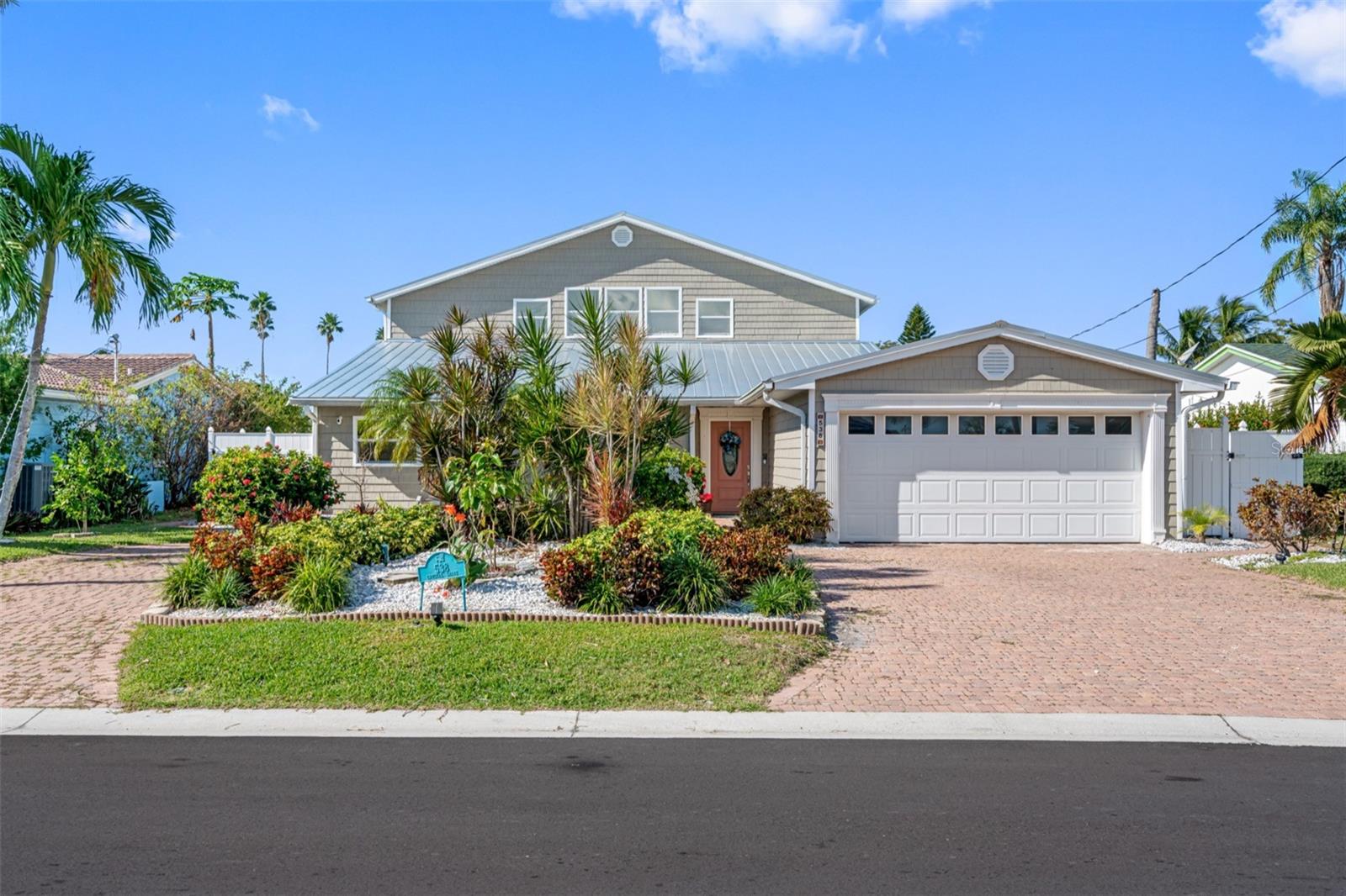 Introducing **Life’s Oasis**, a fully reimagined five-bedroom, four-bath waterfront retreat on coveted **Crystal Island** in Madeira Beach. Encompassing more than 2,800 square feet, this residence showcases over $400,000 in high-end renovations that seamlessly blend luxury with coastal charm. Designed for multigenerational living, it features **dual primary suites**—one on each level. The ground-floor suite is wheelchair-accessible and offers his-and-hers baths, a walk-in closet and private access to the pool, while the upstairs primary enjoys sweeping water views from a balcony and a spa-style bath with multiple shower heads and integrated Bluetooth audio. Two additional bedrooms occupy the main level, and a guest suite with its own bath completes the upper floor.
Perfect for boaters and beachgoers alike, the property is a short stroll from the sand and includes two **boat lifts** (10,000- and 20,000-lb.), a resurfaced **Pebble Tec pool** with a lifetime warranty and brand new pool pump, an extended sun deck and an oversized waterfront patio ideal for entertaining. A redesigned gourmet kitchen, expanded dining area and multiple living spaces with all brand new tile flooring and paint cater to modern coastal living, while **hurricane-impact windows and doors**, two brand new AC systems (2025), a state of the art electrical panel (2021), a covered screened porch (2023), and a metal roof enhance comfort and peace of mind. With renovations just completed, this turnkey waterfront oasis is ready for immediate enjoyment.