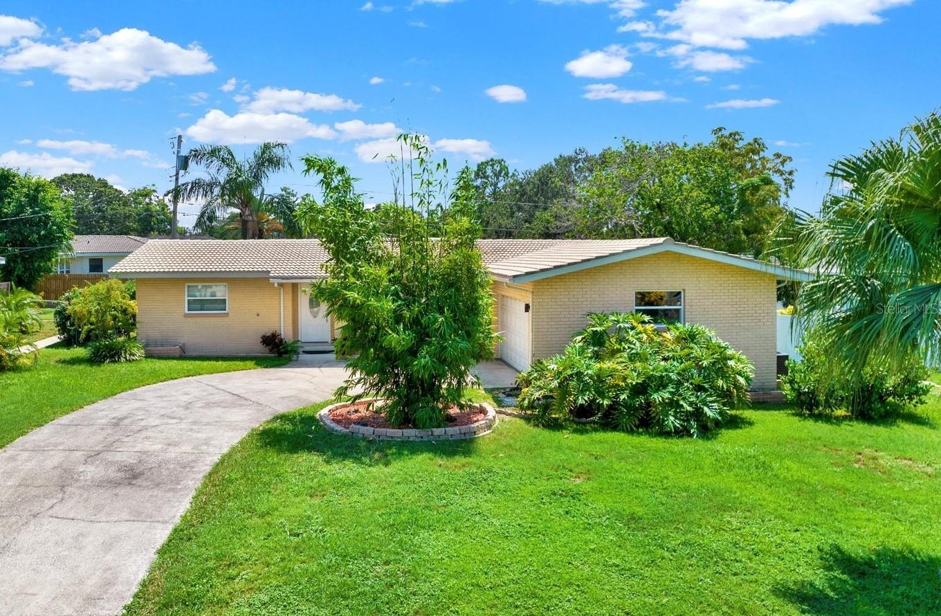 RARE FIND! This beautifully updated home is move-in ready and perfectly situated on an oversized lot in a prime location. It offers plenty of space both inside and out — ideal for entertaining, relaxing, or future possibilities! The home features porcelain tile throughout, spacious bedrooms, two master suites, open floor plan and split bedrooms for privacy. Off the kitchen you will find a separate large dining room that can also be used as an office or entertaining area. Custom built kitchen with beautiful cabinets and newly updated countertops. 2 car garage with an oversized driveway - plenty of space for all your guests! Some other updates include: new kitchen sink and new 5-stages kitchen water filtration system. Recently upgraded well for the irrigation ensures convenience and low-maintenance landscaping. The interior was just freshly painted - ready for the new owners to enjoy this home! The property is located just a short drive to the Downtown shopping and dining, the top beaches and all the water activities!