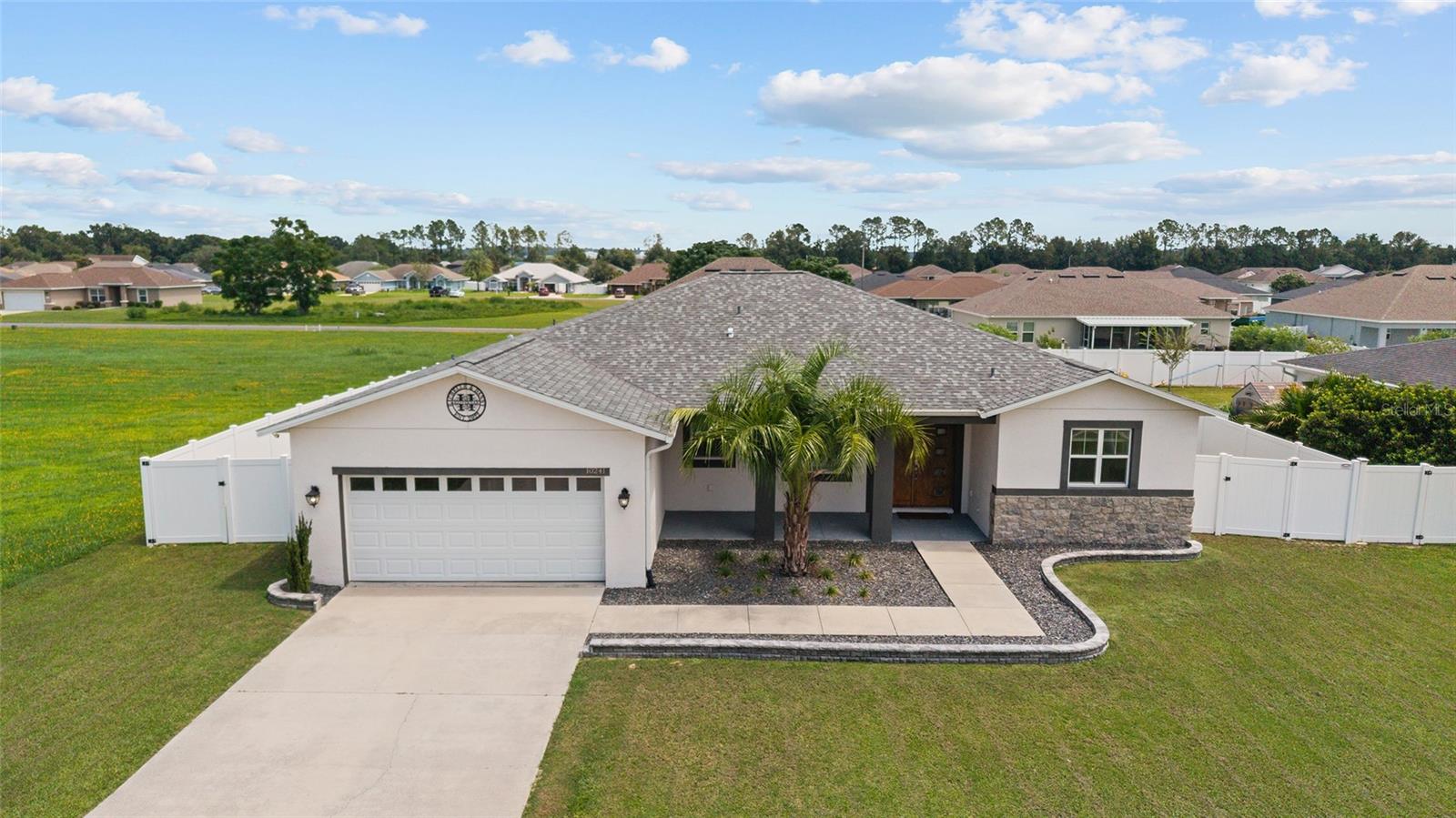 PRICED TO SELL! Beautiful 4/3/2 home in Diamond Ridge! This 2019 built concrete block home has great curb appeal with paver curbing, a covered entryway and double front door. SPACIOUS home with 2232 ft living space! Lots of naturall light! High ceilings and wood plank ceramic tile floors in living areas. OPEN FLOOR PLAN. The kitchen features an island/breakfast bar, SS appliances, backsplash, plenty of cabinets, granite counters, and a walk-in pantry/storage closet. The oversized primary suite has double door entry, lanai access, TWO closets, and an en suite with tiled walk-in shower, garden tub, dual sinks, granite counters, and water closet. SPLIT BEDROOM PLAN. There is an IN-LAW suite with bedroom and private bathroom. Inside laundry room has a barn door. Lanai overlooks large back yard with privacy fence and a paver fire pit area. Great house for entertaining family and friends inside and outside! NO HOA. This home is within walking distance to the Belleview Sportsplex (playground, baseball, basketball, football, soccer, tennis) with shopping, dining, and medical nearby. Convenient location between Ocala and the Villages!