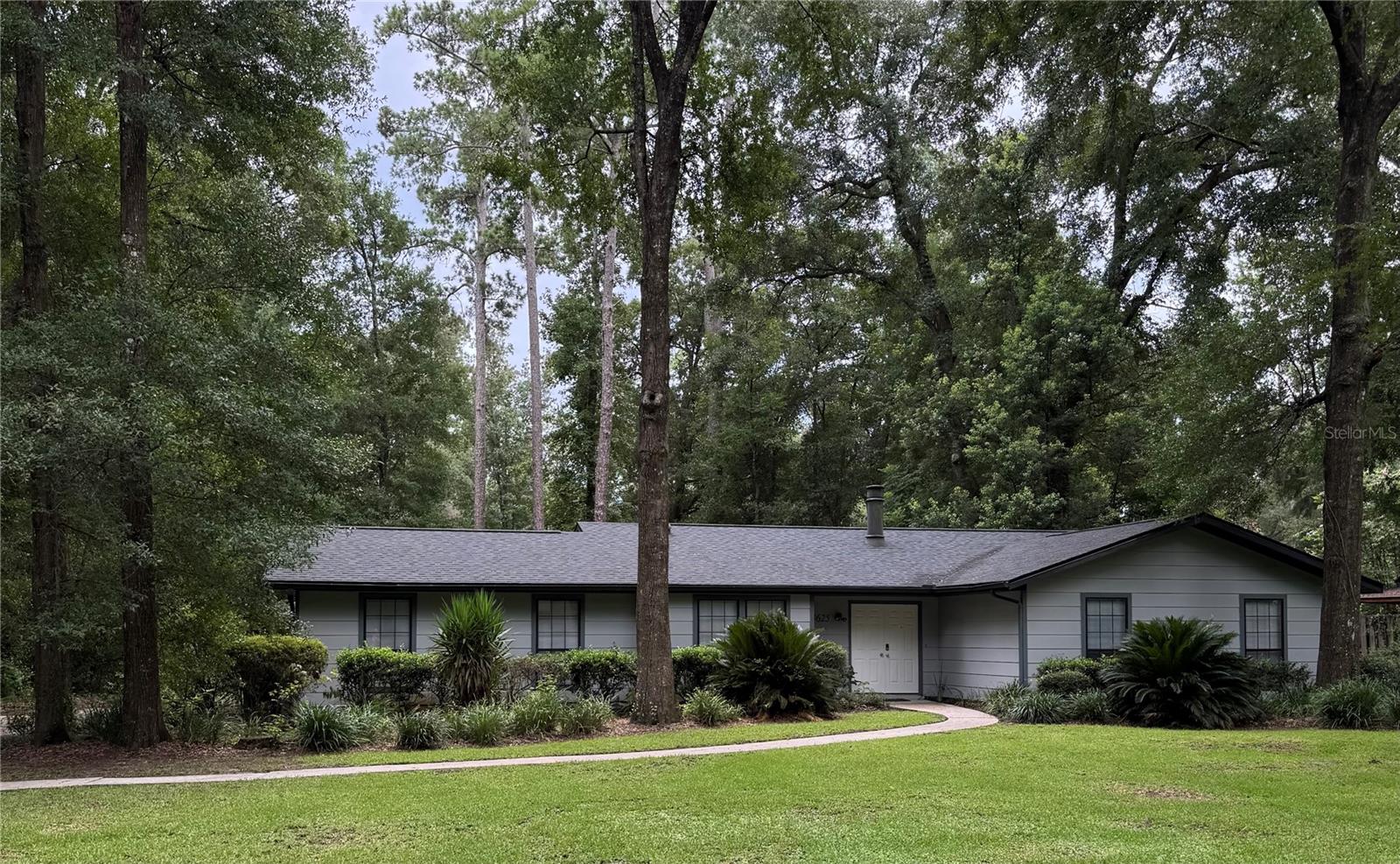 Welcome to your own slice of serenity in one of Gainesville’s most sought-after neighborhoods, Rock Creek! This 1-story ranch home includes 3 bedrooms, 2 baths, and an oversized 2-car garage with a workbench. Your 1,631 sq. ft. home is nestled in this desirable community of northwest Gainesville off NW 34th street. Rock Creek is a hidden gem and is an established neighborhood featuring canopies of age-old oak trees, the charm of quiet, tree-lined streets and local wildlife.
From the moment you step inside your home, you’re greeted by warm natural light and a welcoming vaulted living room centered around a classic brick fireplace, the perfect spot for morning coffee or cozy evenings. Electrical wiring has been added to accommodate a large screen tv over the fireplace or on the opposite wall of the open kitchen. Laminate, vinyl floors and durable tile flow seamlessly throughout, making upkeep a breeze and giving you more time to enjoy life.
The kitchen is the heart of the home, thoughtfully designed with newer wood cabinets, modern appliances and plenty of granite counter space for everything from quick weekday dinners to festive holiday get togethers. Join your friends and family around the kitchen island to counter seating for happy hour or game day parties. The dinette adjacent to the kitchen offers extra space for food prep and storage of items in base cabinets and an oversize pantry. Dedicated laundry room with shelving for storage and hanging clothes is beside the kitchen.
Your private retreat awaits you in the spaciously fenced-in backyard with an outdoor paved patio and fire pit. Perfect for grilling and dining in or outside. Nearly half an acre of space invites endless possibilities, garden to your heart’s content, or simply relax under the shade of mature trees while listening to the breeze. Your pets will enjoy the space and run around to their hearts’ content.
Practicality meets comfort with a spacious two-car garage and a floor plan that fits every stage of life, whether you’re just starting out, raising a family, or downsizing.
The neighborhood is ideally situated just minutes from the University of Florida, top-rated schools, shopping, dining, banking, public library, airport and everyday essentials. This home offers a rare combination of location, lifestyle, and value.
This is more than a home — it’s a lifestyle. Rock Creek’s peaceful setting, friendly community, single entrance and exit, together with couples and families of all ages, pickleball enthusiasts, tennis courts, 25 meter swimming pool, racquetball, basketball, picnic area, park, playground, and unbeatable location make it the perfect place to put down roots. Schedule your tour today and see why this neighborhood is a Gainesville favorite.