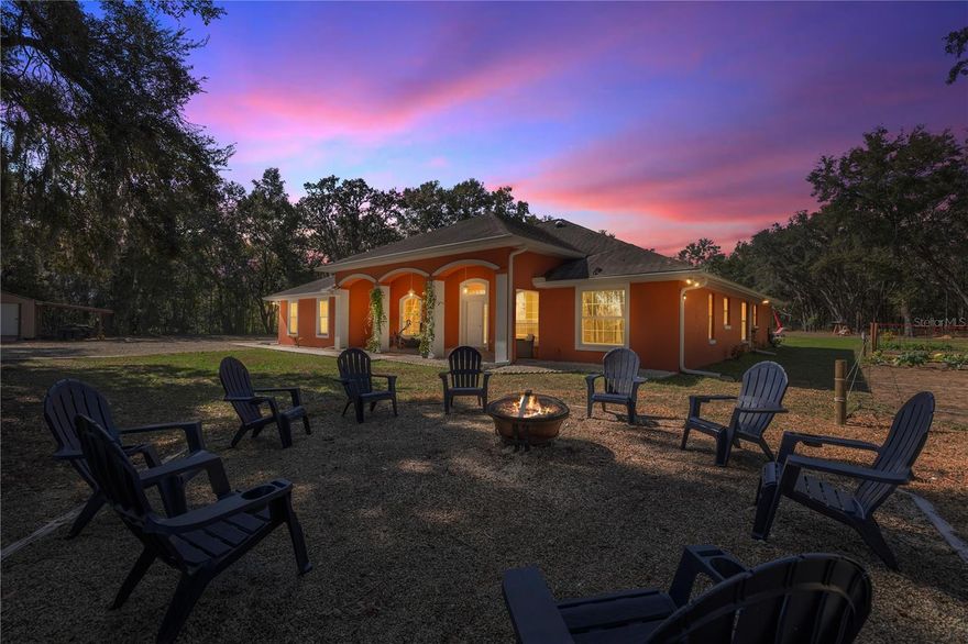 Welcome to your dream retreat! Nestled on 8.65 private acres, this custom-built 4-bedroom, 3-bathroom home with a dedicated office, completed in 2017, offers the perfect blend of modern luxury and rural charm. In 2025, nearly $300,000 in upgrades were added including NEW LOW VOC PAINT that is hypoallergenic inside and out, BRAND NEW HIGH EFFICIENCY AC with UV system for the air ducts which were also deep cleaned last year. An attic fan was also added for energy efficiency. The newly remodeled kitchen has freshly painted cabinets, brand new QUARTZ countertops and 2025 stainless steel appliances including a range. It is a chef's dream! The great room is amply sized for entertaining and opens up to the large covered lanai area. The outdoor area is completely redesigned with a 2025 HEATED SALT WATER VINYL POOL, new BRICK PAVER DECKS and an electric heavy duty pool cover. Gutters were added last year as well as an irrigation system. Owner’s suite is huge with an even larger bath featuring a BRAND NEW TUB, new vinyl floor, new cabinets separate oversized shower, and a huge walk-in closet with a door opening to the laundry room. Additional 3 bedrooms are on the opposite side of the home. The 2nd and 3rd bedrooms share a bath with shower/tub combo, and the 4th bedroom is an en suite with its own private bath and all have new cabinets and countertops. Home has tile, and LVP flooring featuring new LVP in all bedrooms 2022. The outdoor is a gardener's dream. There are 20 fruit trees and a full vegetable garden. Also, there are areas for animals that have water run to them and plenty of room to add space for HORSES. There is even a SMALL BARN for horses! In 2025, a new vinyl privacy fence with gates was added to the front of the property to add both drama and privacy. This property also boasts an attached garage that is INSULATED and has a mini split AC system and brand new EPOXY floors, ample storage space in a convenient shed, and a charming treehouse that promises endless adventures for little ones. Hookups for a home generator and a propane tank are in place as well. Embrace the serene privacy and endless possibilities this stunning property offers—your own slice of heaven awaits! All this and NO HOA!!