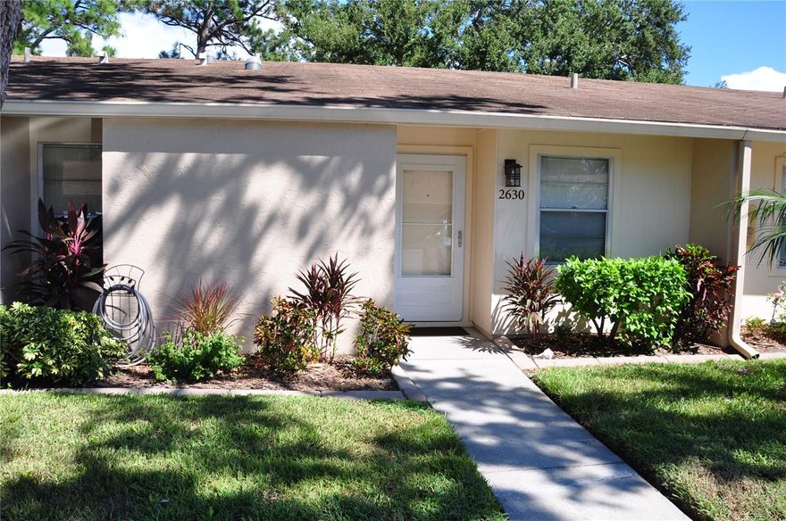 Like new and upgraded gorgeous condo. Minutes from world famous Siesta Key Beach and safely located in flood zone X. All new vinyl plank flooring in living areas and new carpet in bedrooms. Both bathrooms are newly renovated, freshly painted inside and out, along with a total  makeover of the kitchen in 2025. Located in the rear of the development this condo is very quiet and secure. New washer and dryer, make this as good as a new unit. Ceiling fans and skylights keep it light and bright inside. Community heated pool and fitness center are open to the residents at their leisure. Clubhouse includes kitchen, fitness center, pool table and rest rooms with showers. Lanai features fully enclosed glass windows with screens, new storm doors front and rear. Gardener's paradise in the rear with lush tropical plants. In front enjoy your reserved private parking spot. Close to shopping and some of the best restaurants in Sarasota.