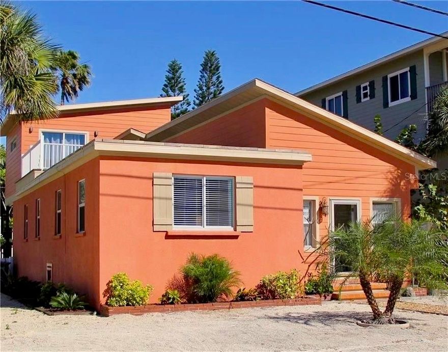 Discover the perfect blend of island history and modern vacation luxury on this highly sought-after corner lot in Bradenton Beach on Anna Maria Island. This 3 bedroom, 3.5 bathroom originally built in 1959—and rumored to have once housed the island’s telephone hub—this home was constructed to endure. This island oasis sustained NO STORM DAMAGE, offering you peace of mind.  Inside, you’ll find low-maintenance, water-resistant flooring throughout—perfect for sandy feet and beach living. The thoughtful layout features a full kitchen and offers excellent accessibility, with two of the three bedrooms located conveniently on the main floor.  As you retire for the evening, downstairs you will find an oversized master king bedroom and ensuite bath complete with walk-in shower, large vanity, and Jacuzzi tub.   Upstairs, you will find the 2nd bedroom with a king bed and private ensuite bathroom. Enjoy the partial beautiful Gulf views from this bedroom.  Downstairs also features the 3rd bedroom complete with two twin-over-twin bunk beds (4 twins total).  There's a full size washer and dryer in the downstairs 1/2 bath off the kitchen.  Outside is a fully fenced backyard with established landscaping and a sparkling, private heated pool with a custom sundeck.  The location is simply unbeatable. Situated in the tranquil Mid-Island area, you are away from the chaos but minutes from the action. Stand in your driveway and look left to see the crystal blue Gulf, or look right to see the Bay.  Launch a kayak nearby, take a sunset stroll, or drive a few minutes to Bridge Street. With No HOA and plenty of parking, the choice is truly yours. Great vacation rental and investment with $37k in bookings already for 2026.