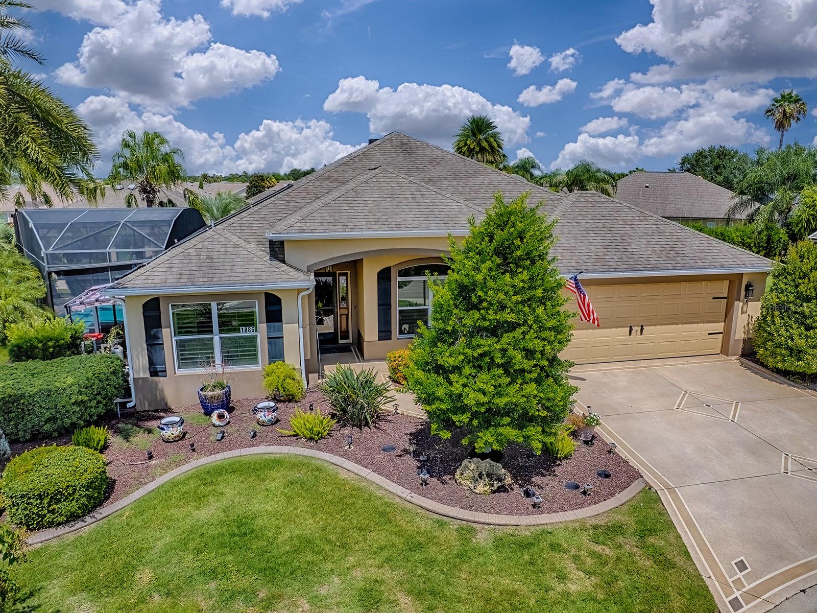 Surrounded by lush, mature landscaping, this beautiful Aspen- Model 'POOL HOME' is a Private Retreat in The Village of St. James. A decorative drive & walkway, extended garage and a welcoming entry sets the tone for the elegance inside. Thoughtful upgrades are found throughout-gleaming granite countertops with complimentary backsplash, rich wood cabinets, plantation shutters, updated primary bath, and carpet-free floors. Airy, Open feel throughout this home including an oversized Enclosed Lanai with MINI-SPLIT for year-round comfort. Enjoy socializing or relaxed evenings around the pool (solar heated) and patio which is equipped with an automatic Sun Setter Awning! The Kitchen has Stainless Steel Appliances, Plenty of Cabinet Space, Closet Pantry with Pullouts. The Primary Suite has a tray ceiling and is very spacious with upgraded EnSuite Bath including double sinks, granite top vanity, custom tiled wall, linen closet, and a large Walk-in Roman Shower. Two Guest Bedrooms, on the opposite side of the home, have built-in closets and provide comfort and privacy for family and/or guests. Ideally located just minutes from golf, dining, shopping, and endless recreation- THIS HOME MAKES EVERY DAY FEEL LIKE VACATION!! The Village of St. James offers residents a prime location between Lake Sumter Landing and Brownwood.