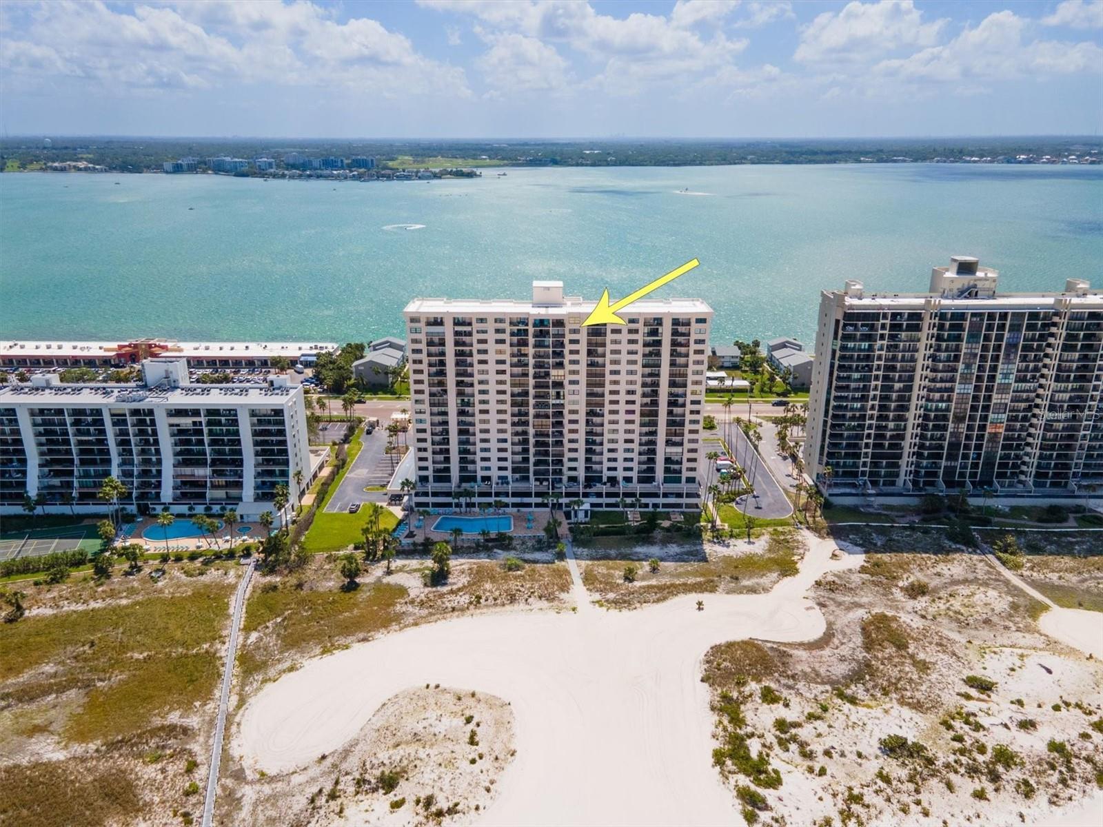 Experience beachfront living at its finest in this 19th-floor condo at Harbour Light Towers, located directly on the powdery sands of Clearwater Beach. This 1-bedroom, 1.5-bathroom residence is being sold **FULLY FURNISHED**, offering a turnkey opportunity for personal enjoyment or rental income. From the enclosed Florida room—undamaged by recent storms—take in panoramic unobstructed Gulf views, while the Intracoastal Waterway can be viewed from the kitchen, offering a unique dual-water perspective. The thoughtfully designed layout includes a spacious walk-in closet, an en suite bath in the primary bedroom, and a convenient half bath for guests. The unit needs some TLC, providing a blank canvas to create your own beachside escape. A washer and dryer and private storage locker are located just steps from your front door for added convenience. Harbour Light Towers is a secure, gated beachfront community known for its well-maintained grounds and resort-style amenities. Residents enjoy a sparkling waterfront pool, guarded entry with 24-hour camera surveillance and coded access, and peace of mind from recent updates including a **NEW ROOF** and **COMPLETED MILESTONE STUDY**. The monthly fee covers cable TV, water, sewer, trash, pest control, building insurance, exterior maintenance, and reserves. **30-DAY MINIMUM RENTALS ARE PERMITTED**, enhancing investment potential. Ideally situated near Clearwater Beach’s top attractions, dining, and shopping, this is your opportunity to enjoy Florida coastal living at its best.