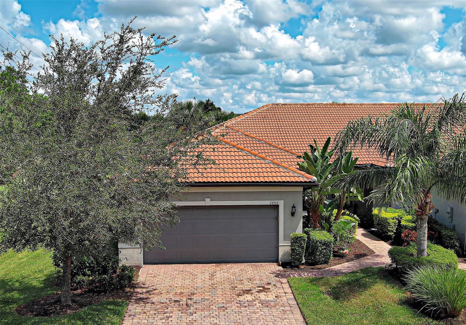 Beautifully FURNISHED and TURNKEY, this Cascadia villa in Islandwalk is perfectly positioned on a PREMIER LOT at the end of a peaceful CUL-DE-SAC, offering PRIVACY, TRANQUILITY, and stunning WATER VIEWS. Designed for comfort and peace of mind, this home includes thoughtful UPGRADES such as HUNTER DOUGLAS pull-down accordion blinds, TILE FLOORING in main areas, STORM SMART PROTECTION on the front window, ACCORDION SHUTTERS, and REMOTE-CONTROLLED storm protection for the lanai. This home is tastefully decorated and has a soft coastal vibe with easygoing neutral tones that that will easily adapt to your personal style.
The sought-after split floor plan features a spacious kitchen with Whirlpool appliances, granite countertops, a coordinating backsplash, recessed lighting, and a charming breakfast nook, ideal for enjoying your morning coffee. The dining area flows effortlessly into the sun-filled living room, where SLIDING GLASS DOORS frame picturesque water views and create a SEAMLESS INDOOR-OUTDOOR CONNECTION.
The primary bedroom is a serene retreat with water views, a ceiling fan, and an en suite bath featuring dual vanities, a walk-in shower with glass door, and both a walk-in and built-in closet for generous storage. The versatile flex room, with tile flooring and FROSTED GLASS FRENCH DOORS, offers the perfect space for a home office, craft room, or third bedroom.
The guest bedroom includes carpet, a built-in closet, and a ceiling fan, while the adjacent full bath features a dual vanity and a bathtub with a safety grab bar. A linen closet adds extra storage, and the equipped laundry room is conveniently located between the guest bedroom and bath.
The two-car garage includes an INSULATED DOOR for added efficiency. Step out to the lanai and enjoy peaceful water views and FULL STORM PROTECTION, ensuring year-round comfort and security. This home also comes with a TRANSFERABLE HOME WARRANTY, making it a truly worry-free and move-in-ready opportunity in one of Islandwalk’s most desirable locations.
Future connectivity to Manasota Beach Road (projected to be done by August 2026) will enhance this home’s already excellent accessibility. Residing in Islandwalk will give you a sense of resort-style living all year around since it is a very active community with rich amenities including geothermal pools, Har-Tru tennis, pickleball and bocce ball, lap pools, spas, playground, basketball court, a dog park, two State-of-the-Art Fitness Centers, a 24 hr staffed front gate, on site 7 day/week HOA staff, outdoor pavillions with BBQ grill, a library and much more that will keep you and your guests active and engaged. Golf carts are permitted throughout the community and can be taken out of the community if registered. Enjoy exclusive access through a resident-only back gate to the exciting Downtown Wellen Park, featuring a Marketplace anchored by Publix, Atlanta Braves ballpark, restaurants. Conveniently located just 4 miles from I-75, it offers easy access to multiple pristine Gulf beaches and airports. Historic Venice Island, and cultural events are just a short drive away.